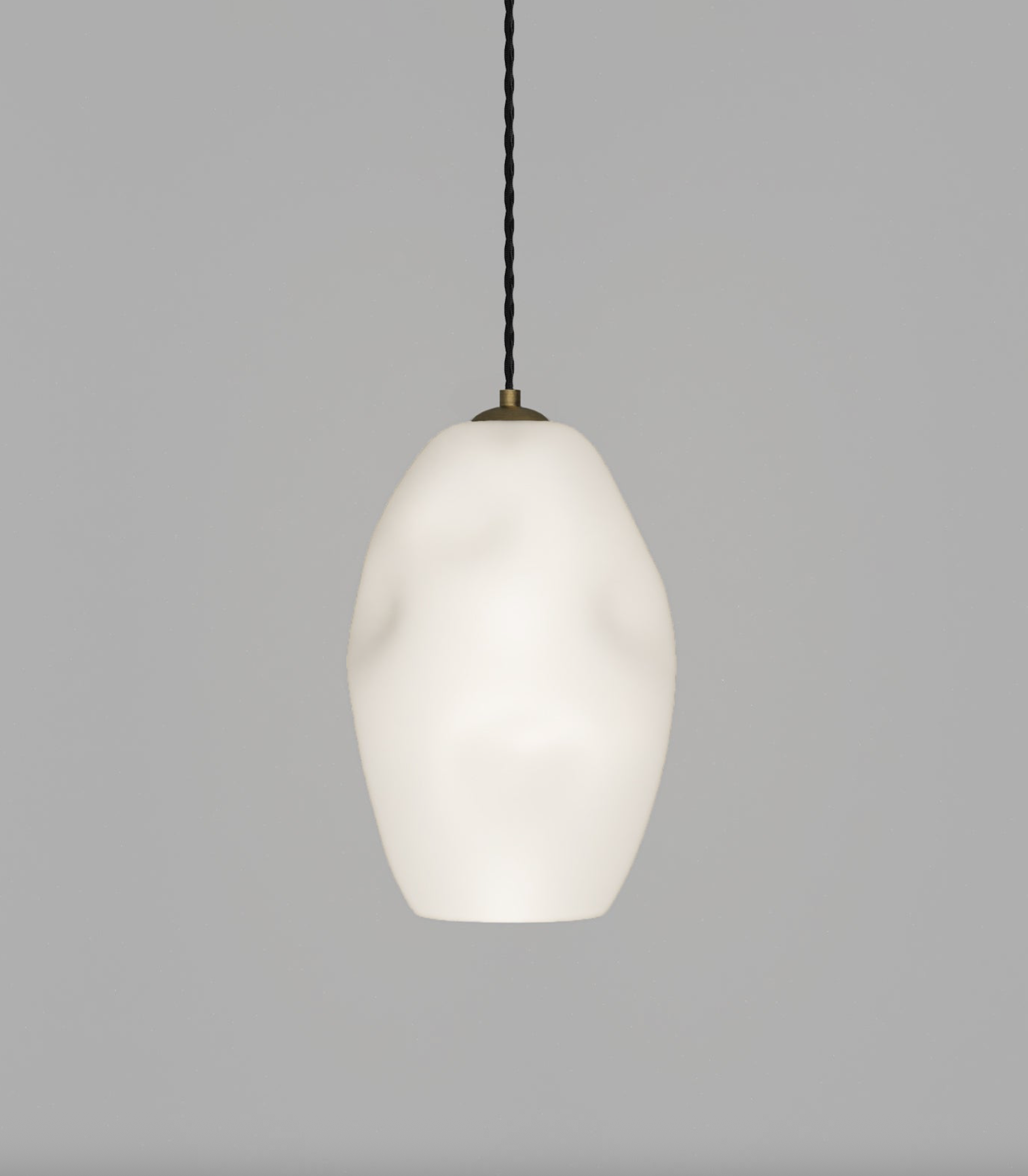 White glasspendant light with a black cord on a gray background