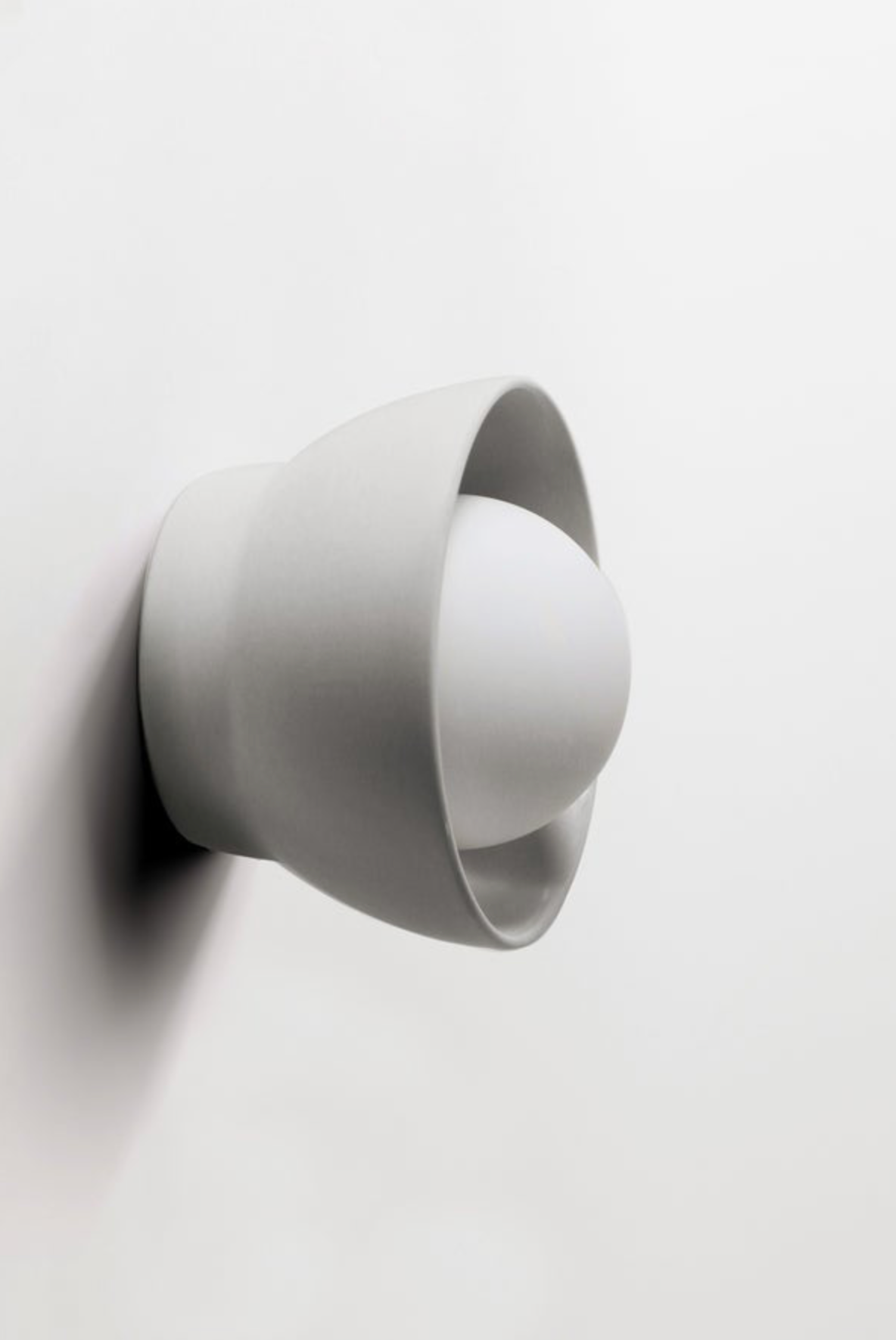 White wall-mounted lamp on a light background