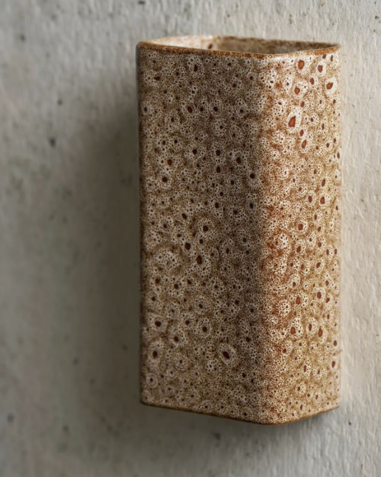 Textured ceramic vase on a concrete surface