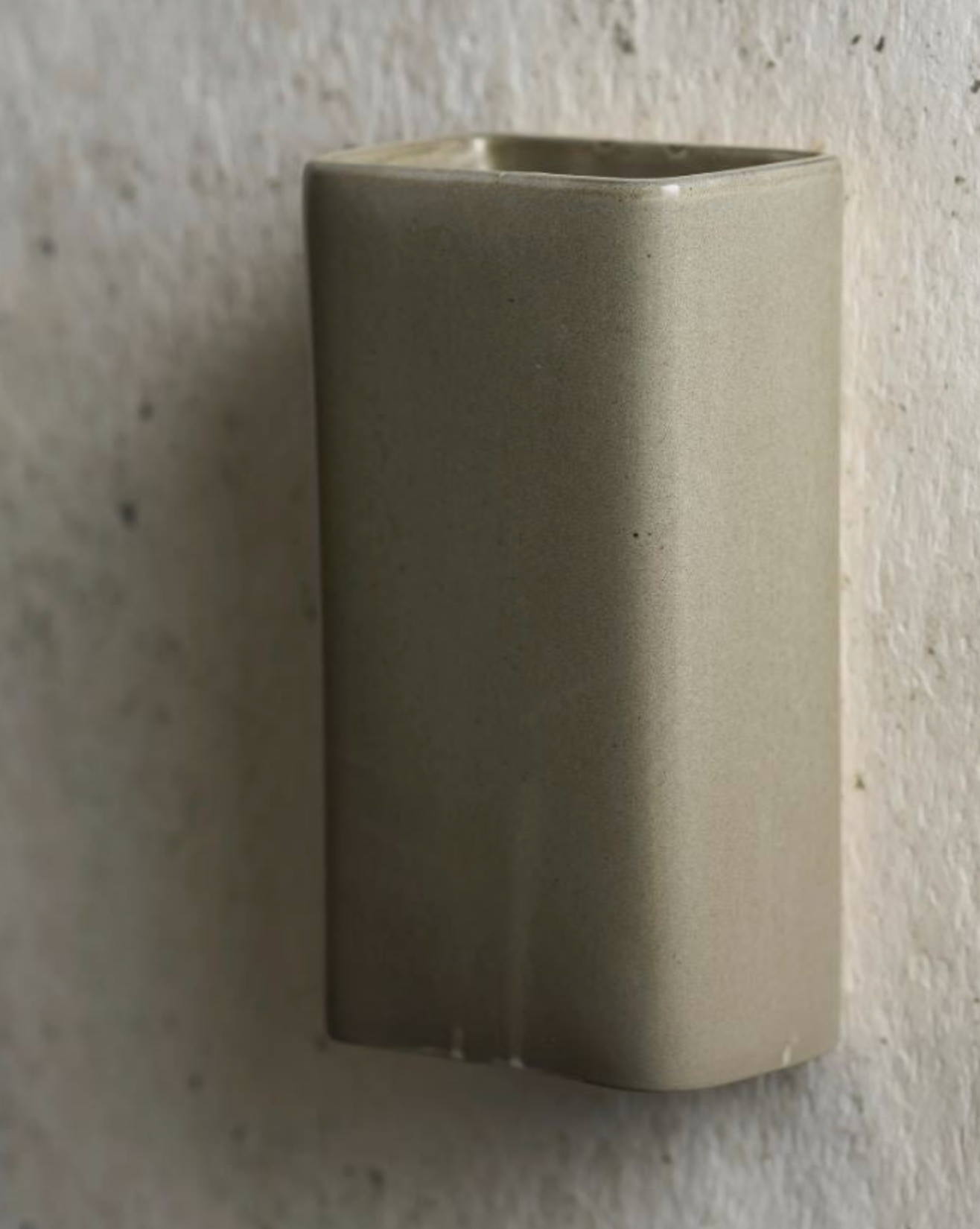 Rectangle ceramic wall-mounted light on a textured background