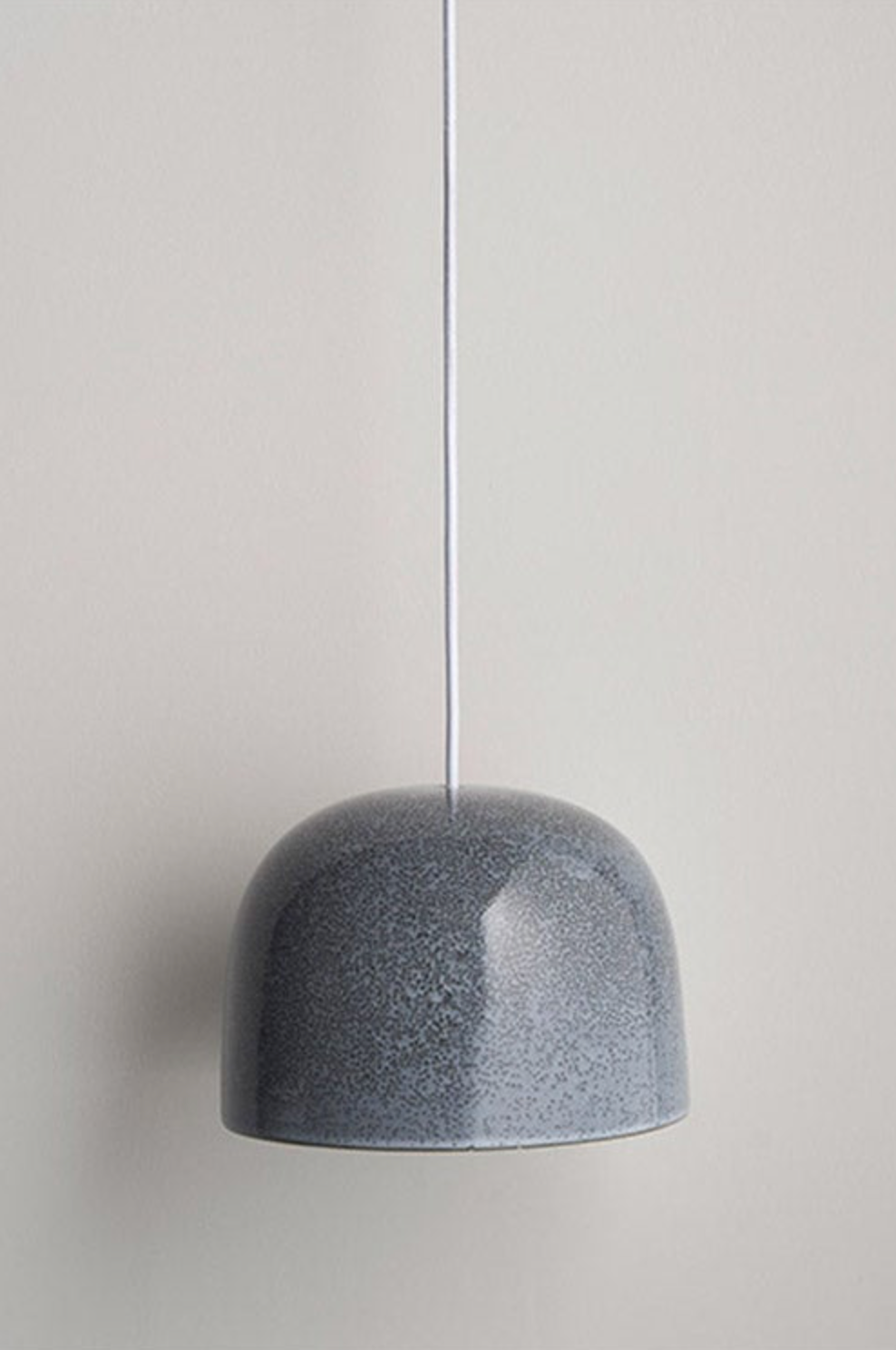 Grey ceramic pendant light on a neutral background