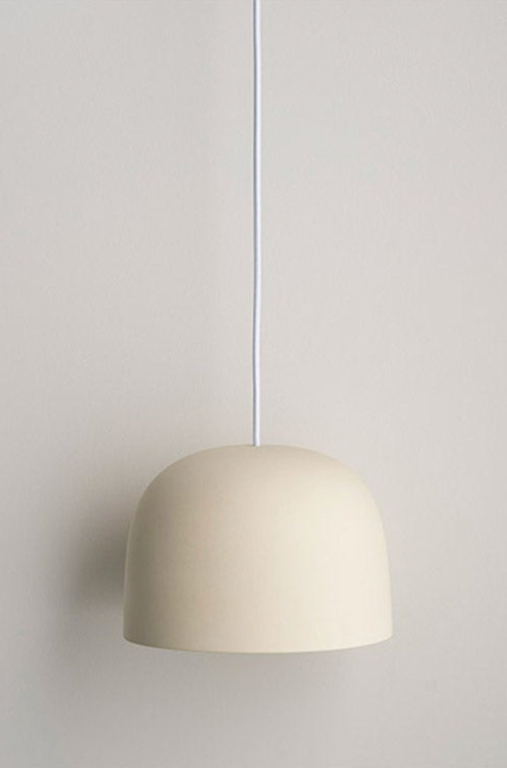 Beige pendant light against a plain wall