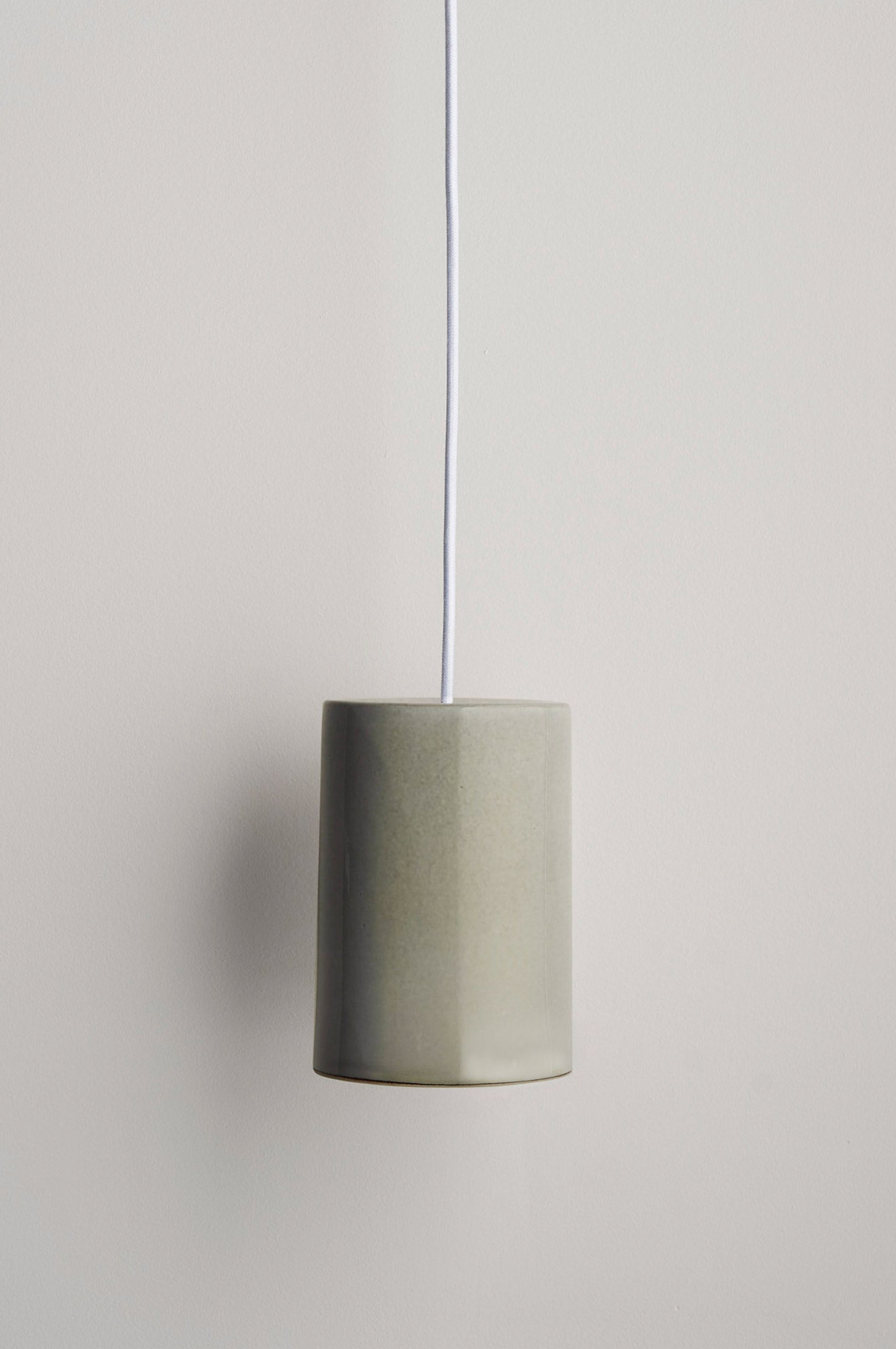 Ceramic interior pendant light on a plain background