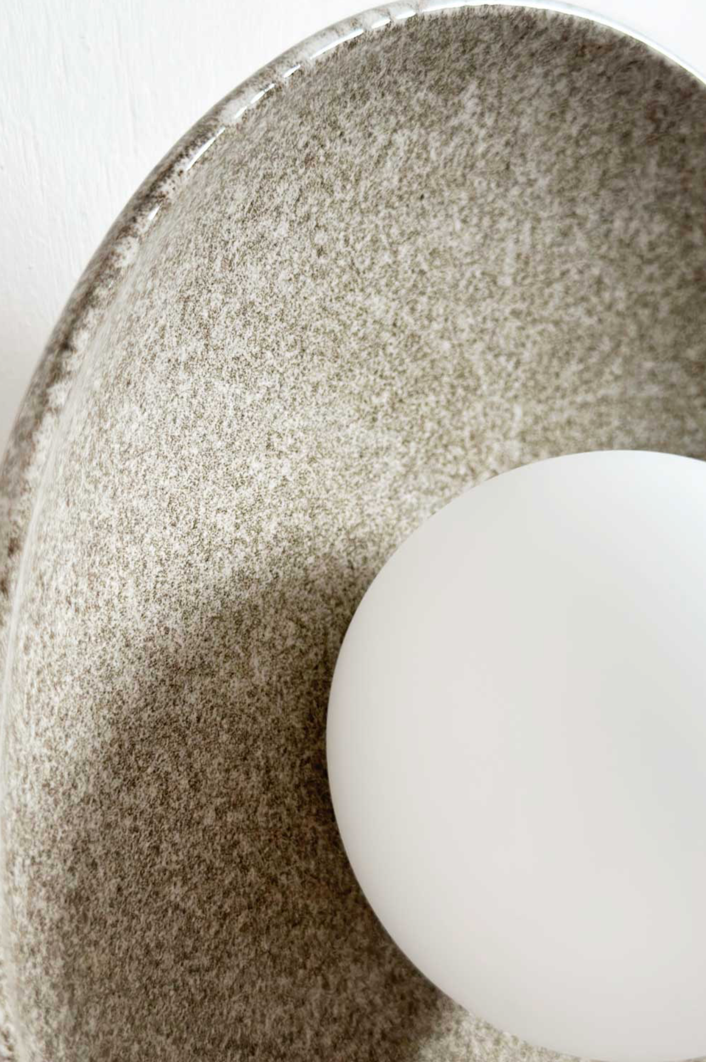 Interior wall light on a textured ceramic surface
