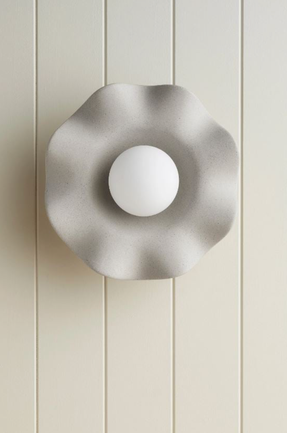 Modern ceramic wall-mounted light fixture on a neutral background