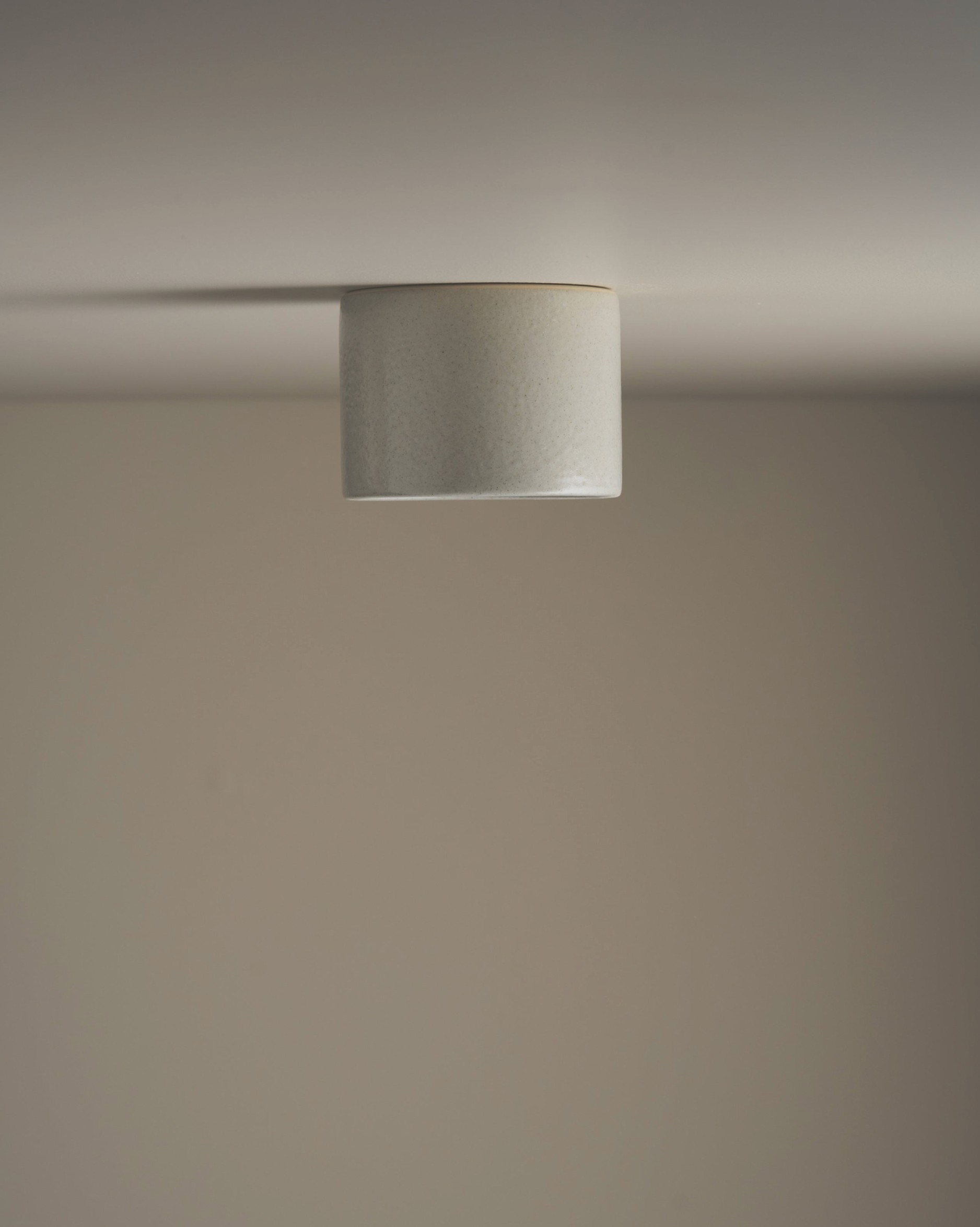 Ceramic ceiling light fixture on a neutral background
