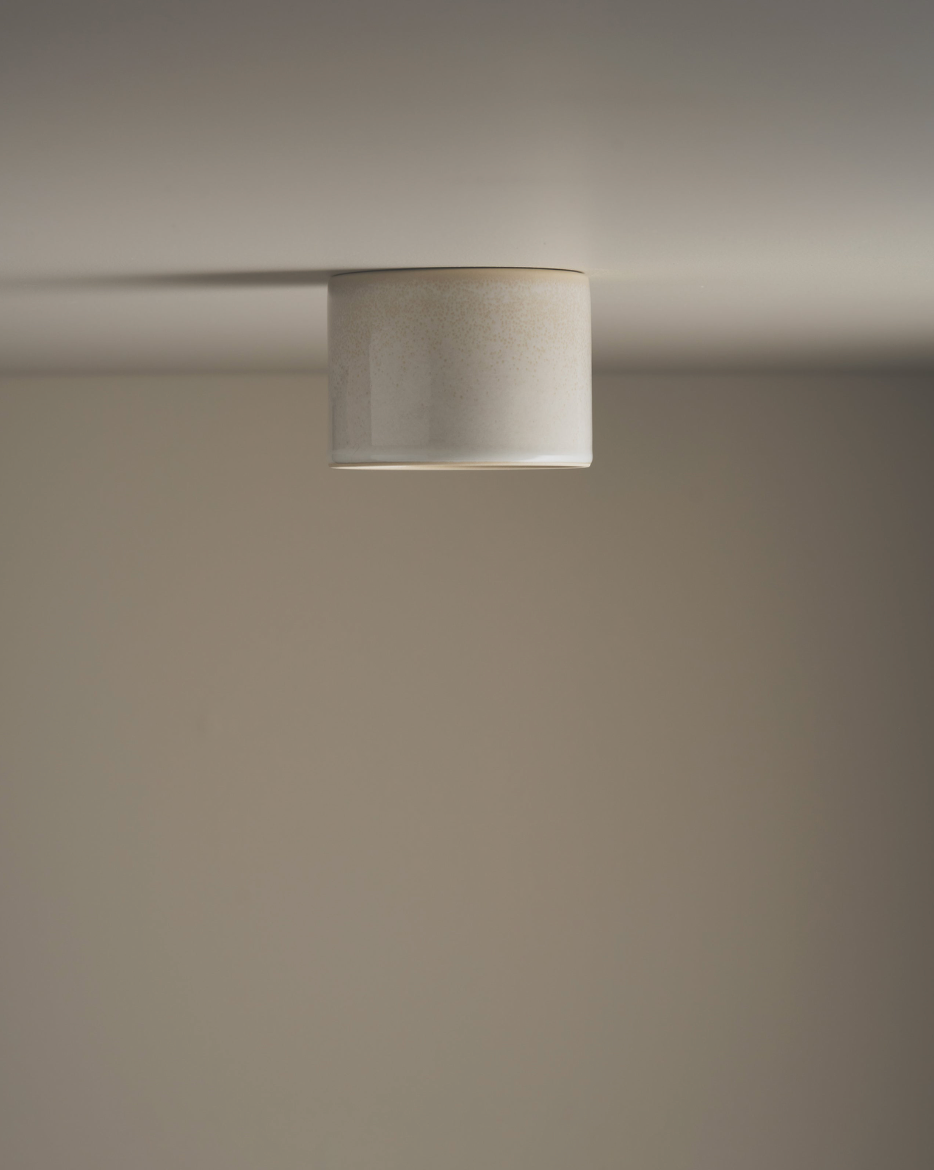 Ceramic ceiling light fixture on a neutral background