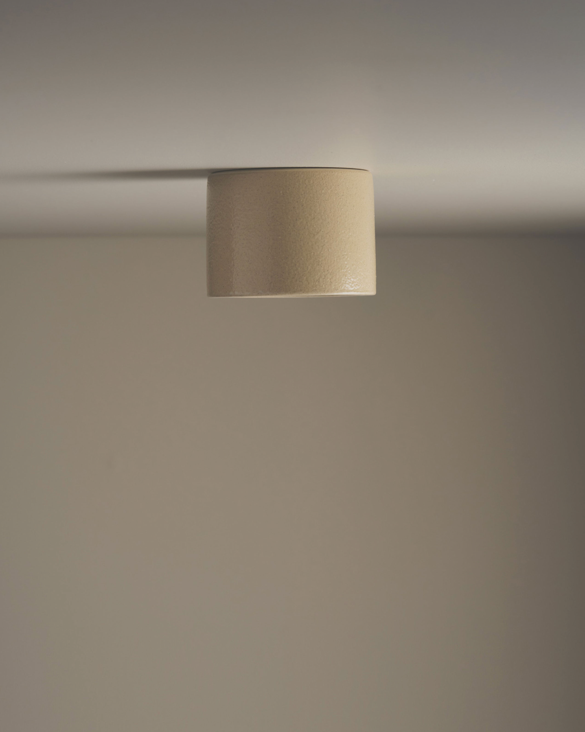 Ceramic ceiling light fixture on a neutral background