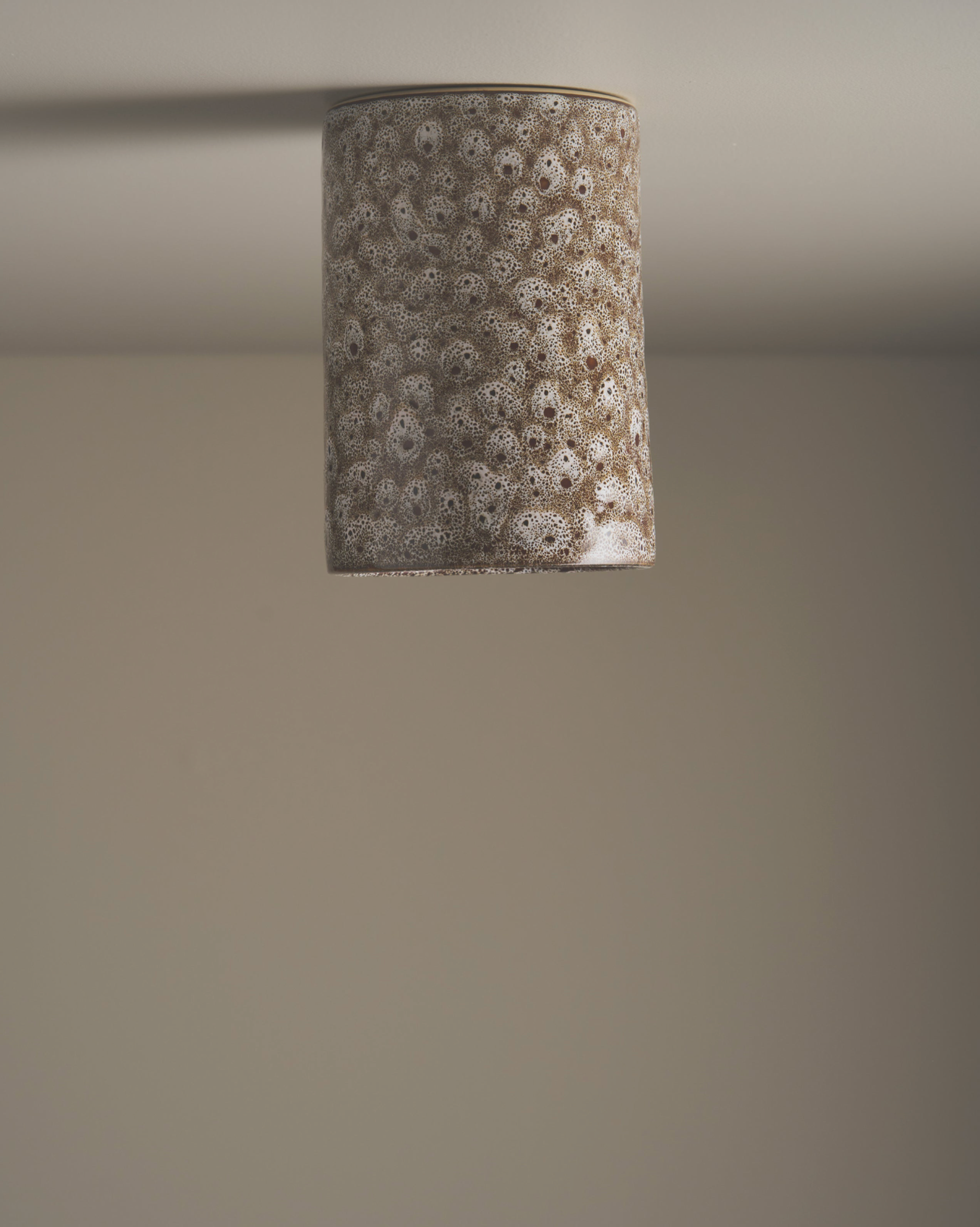 Cylindrical lampshade with floral pattern on a plain background