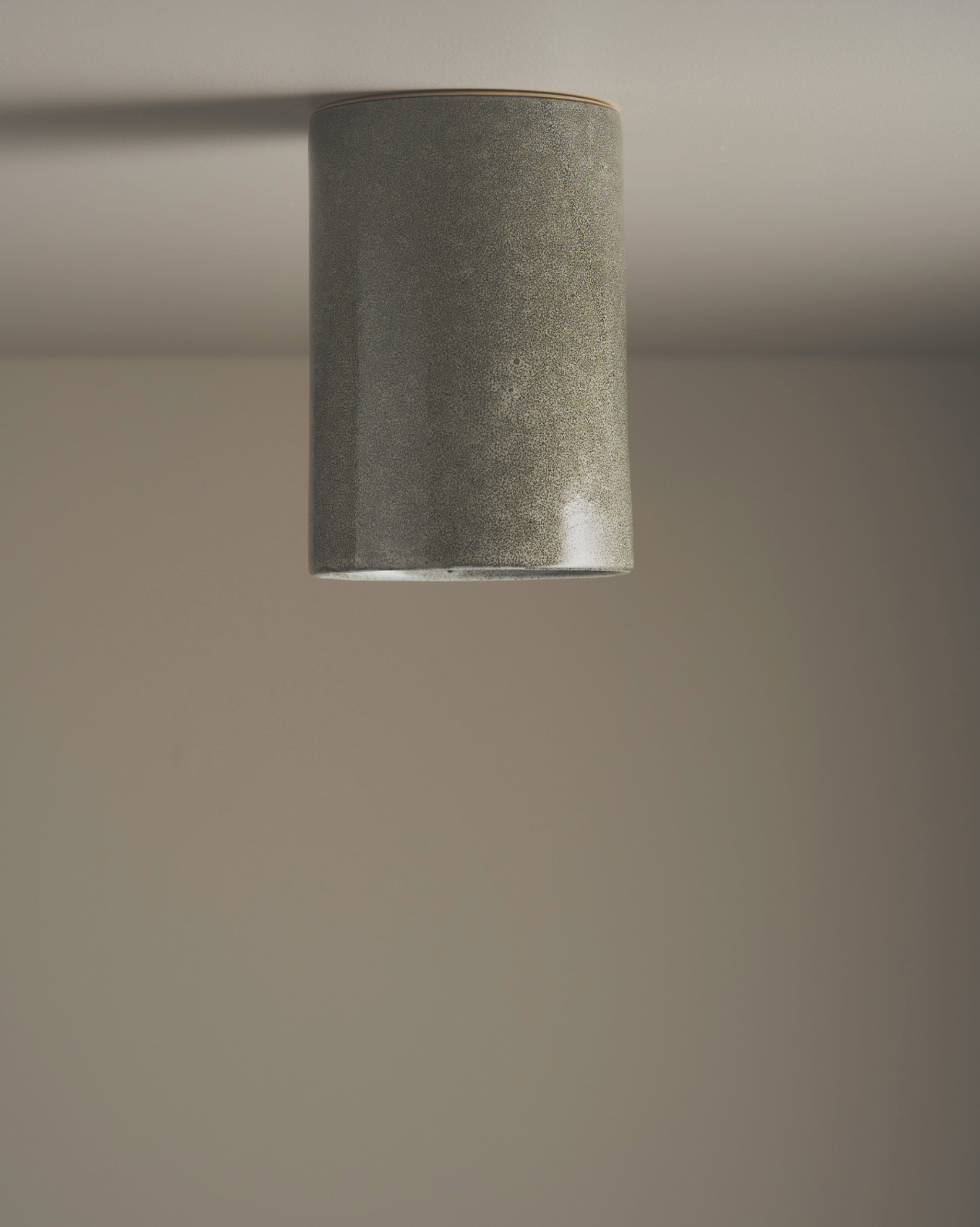 Cylindrical light fixture on a plain wall