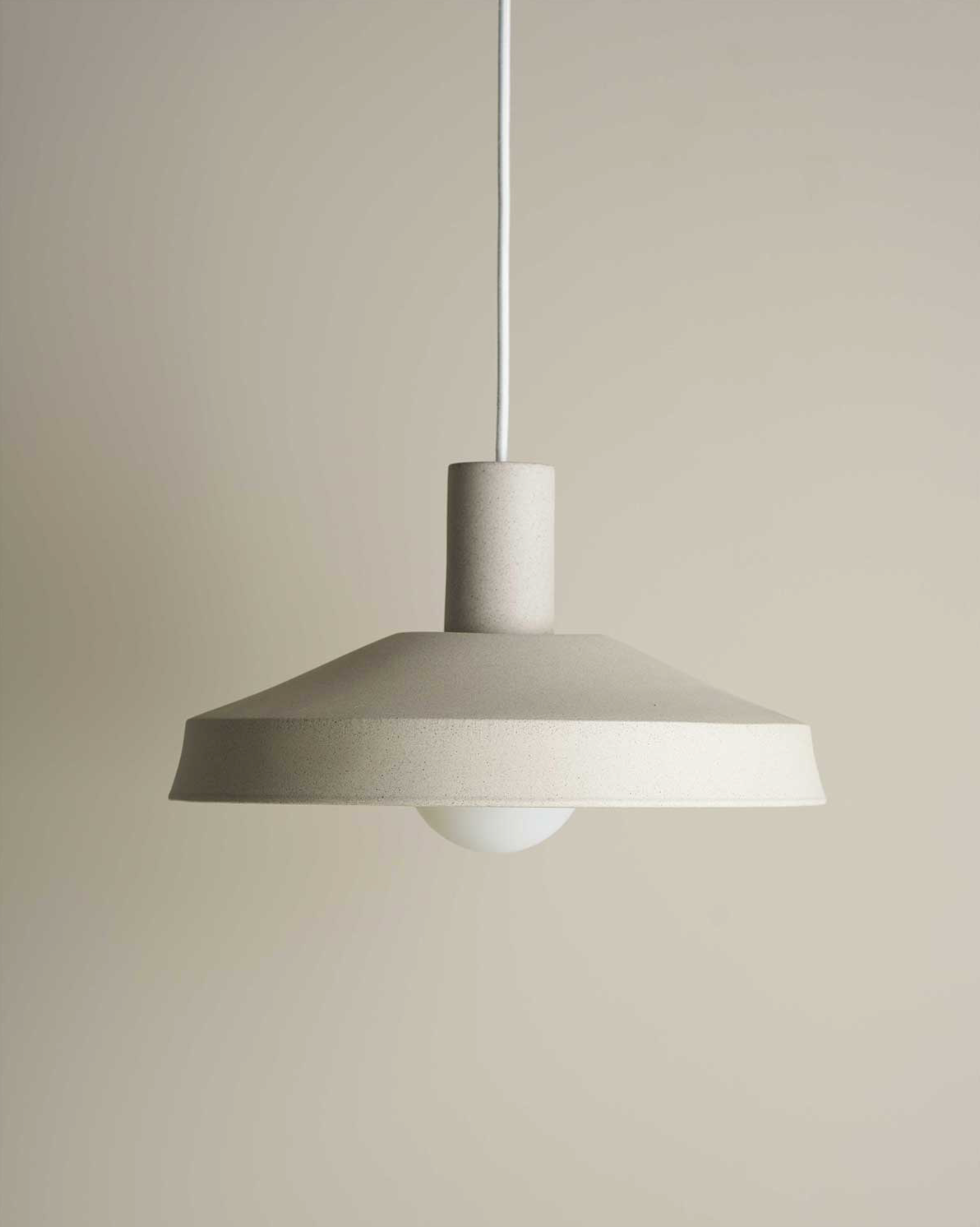 Ceramic pendant light on a beige background