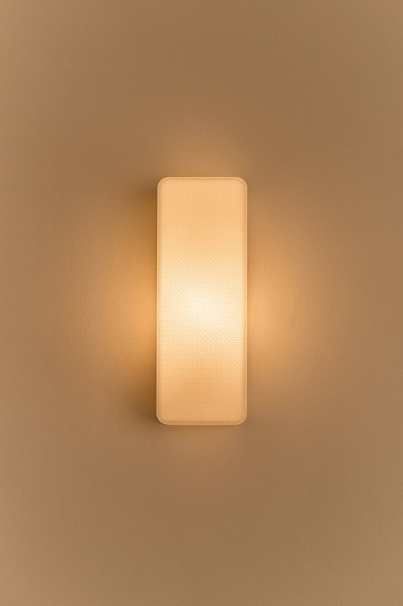 Rectangular 3D printed wall light fixture on a beige wall