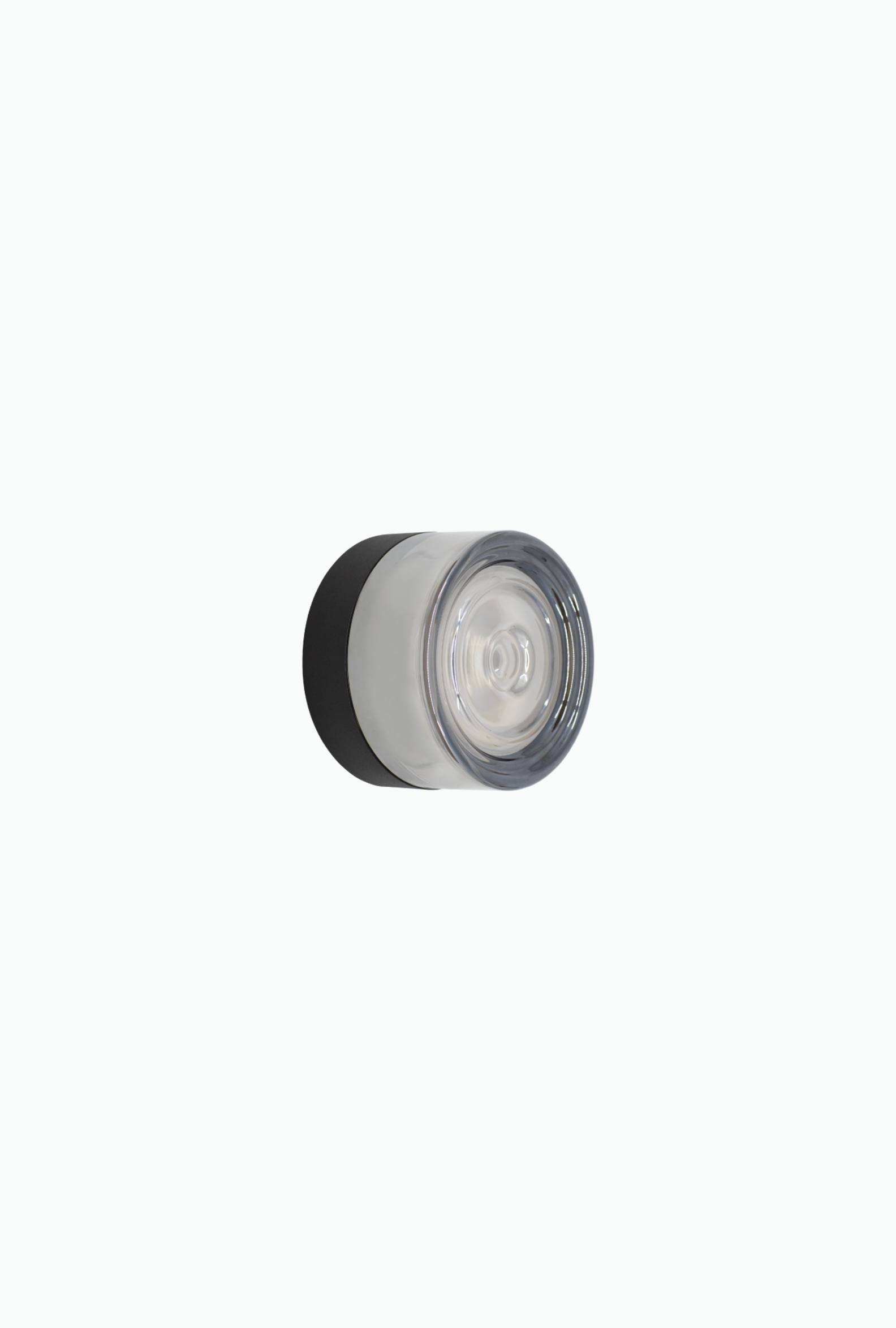 Round grey smoked glass wall light with a white center on a white background