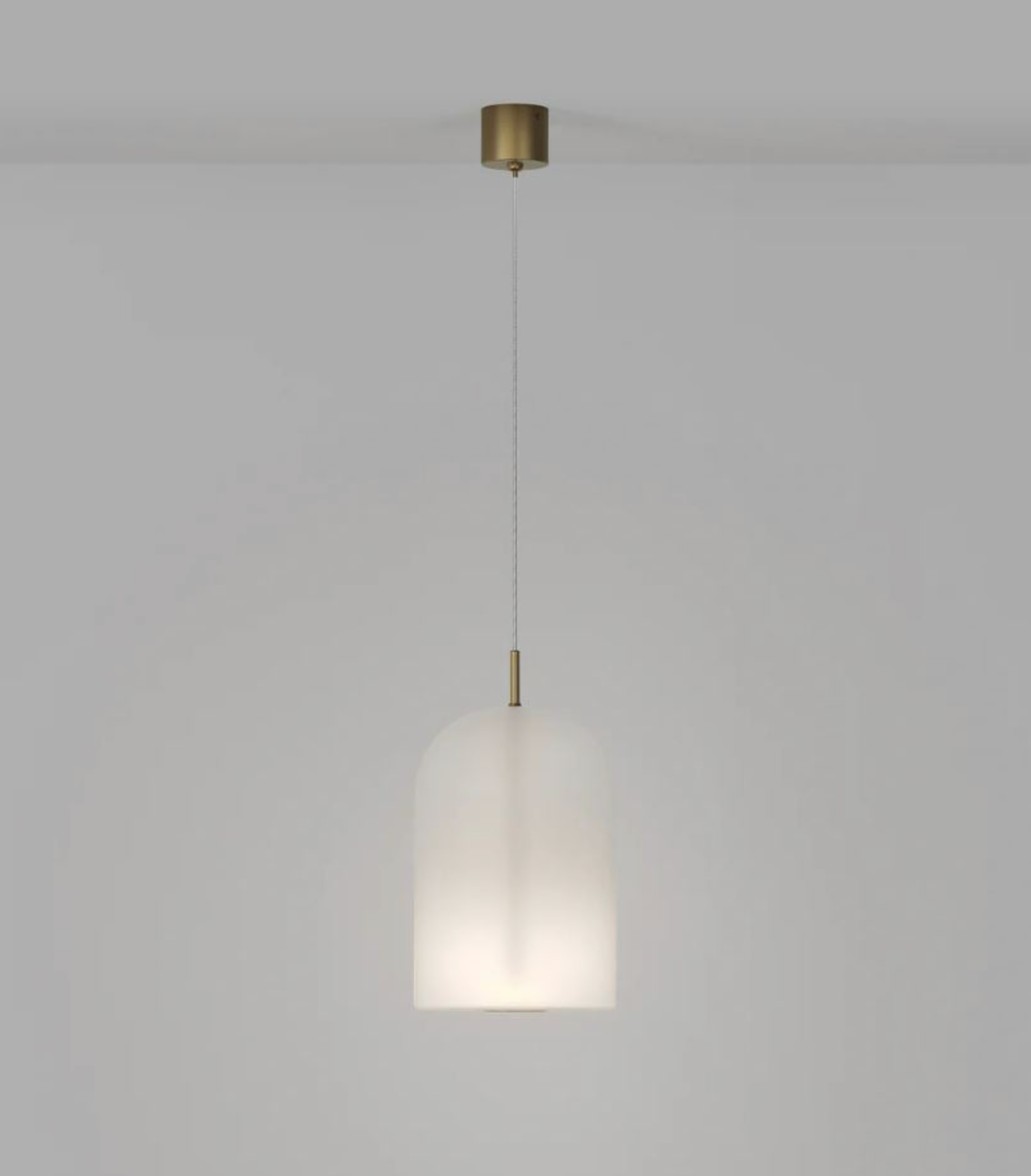 Pendant light with a white glass shade and gold fixture on a plain background