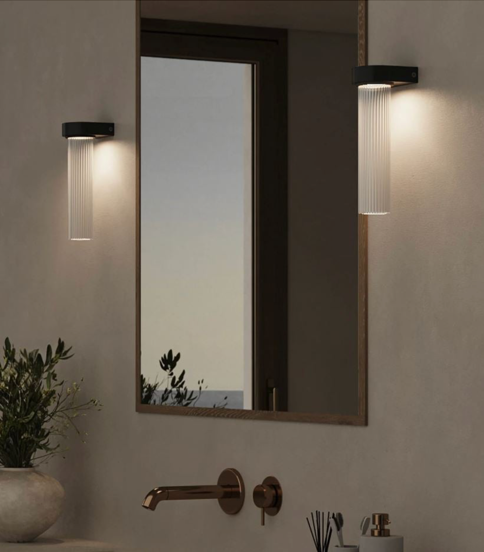 Modern bathroom setup with a large mirror, wall lights, and decorative elements.