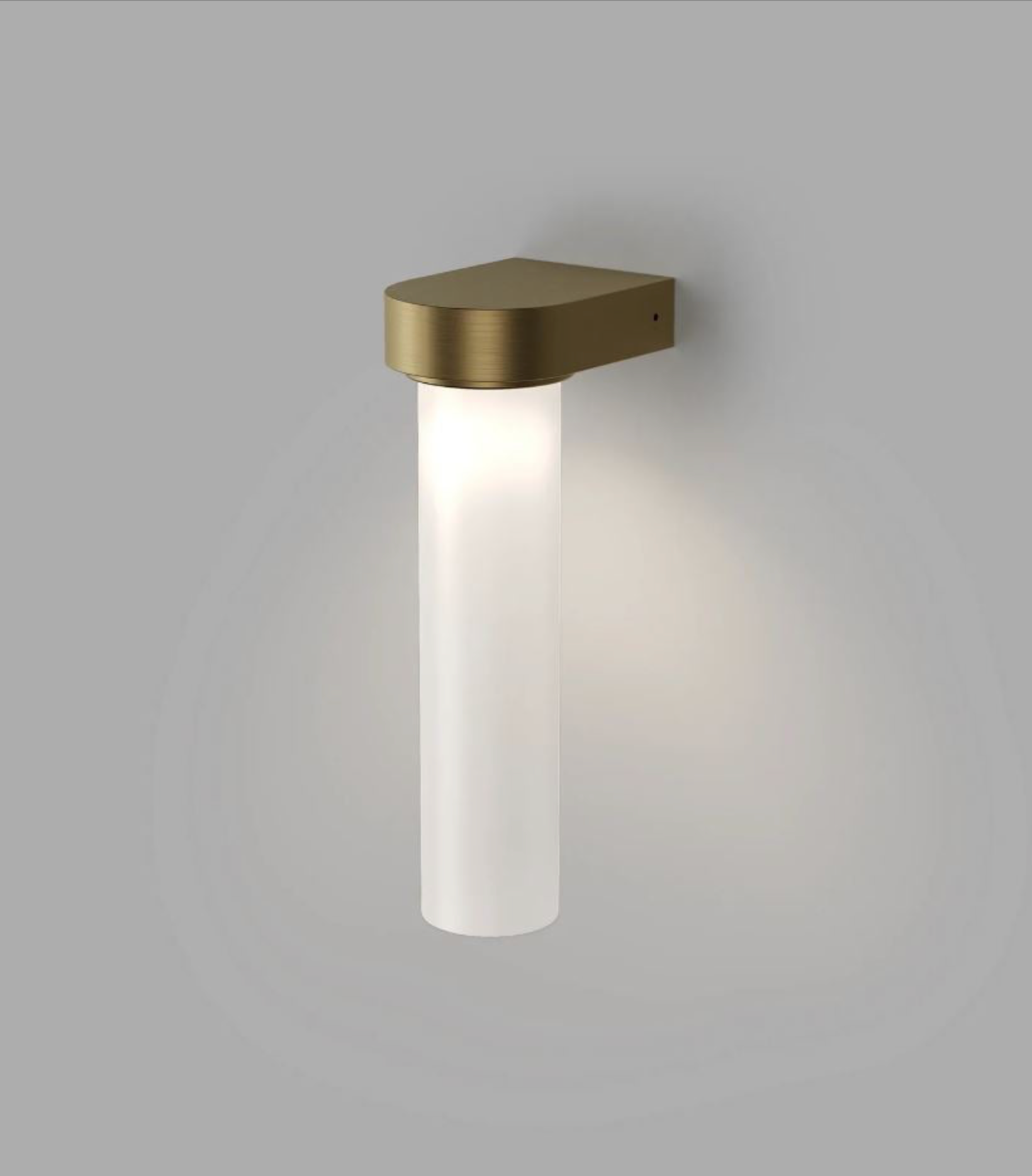 Wall-mounted light fixture with brass finish on a gray background