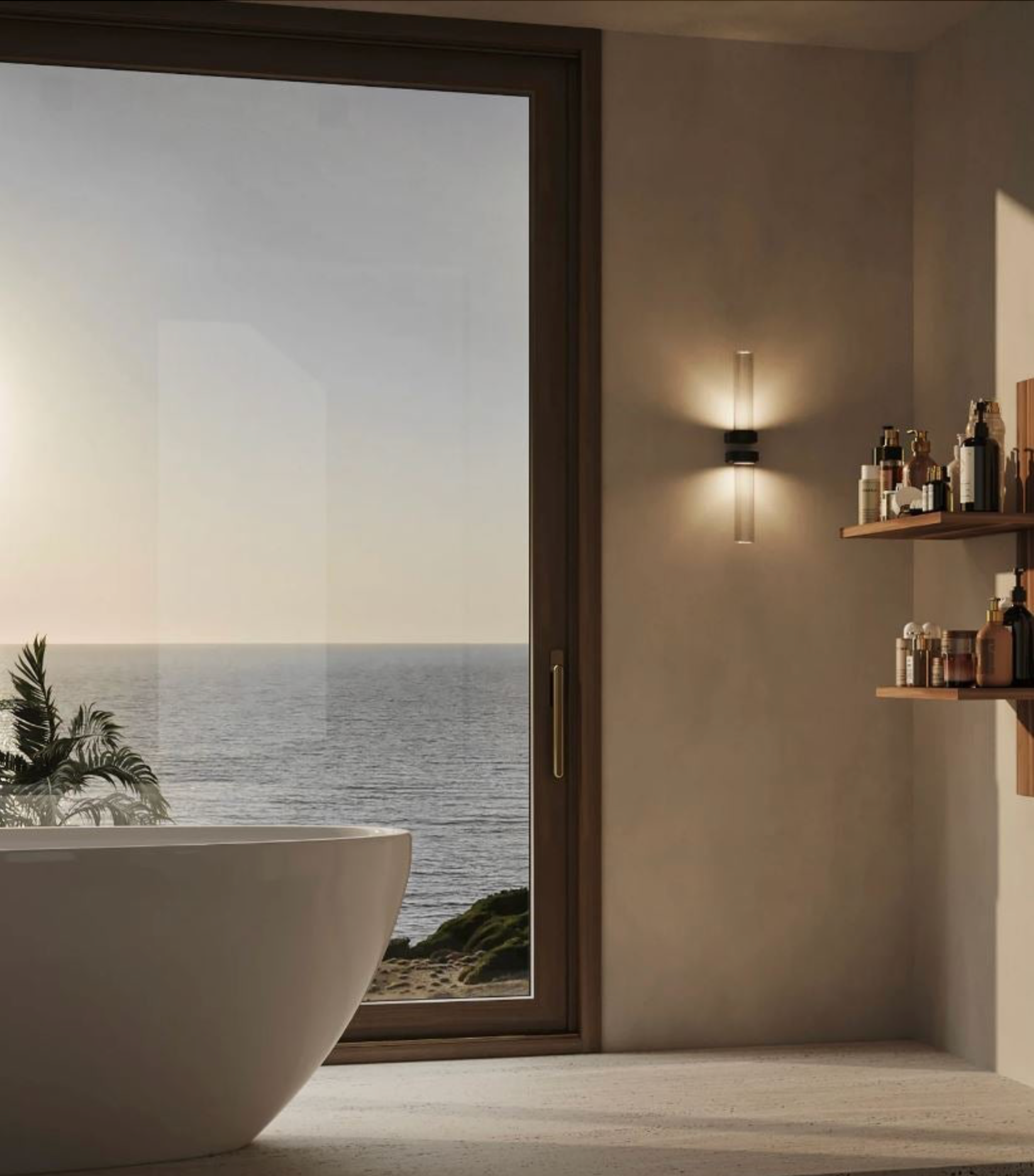 Bathroom with a large window offering a view of the ocean, feature wall lights and a white freestanding bathtub.