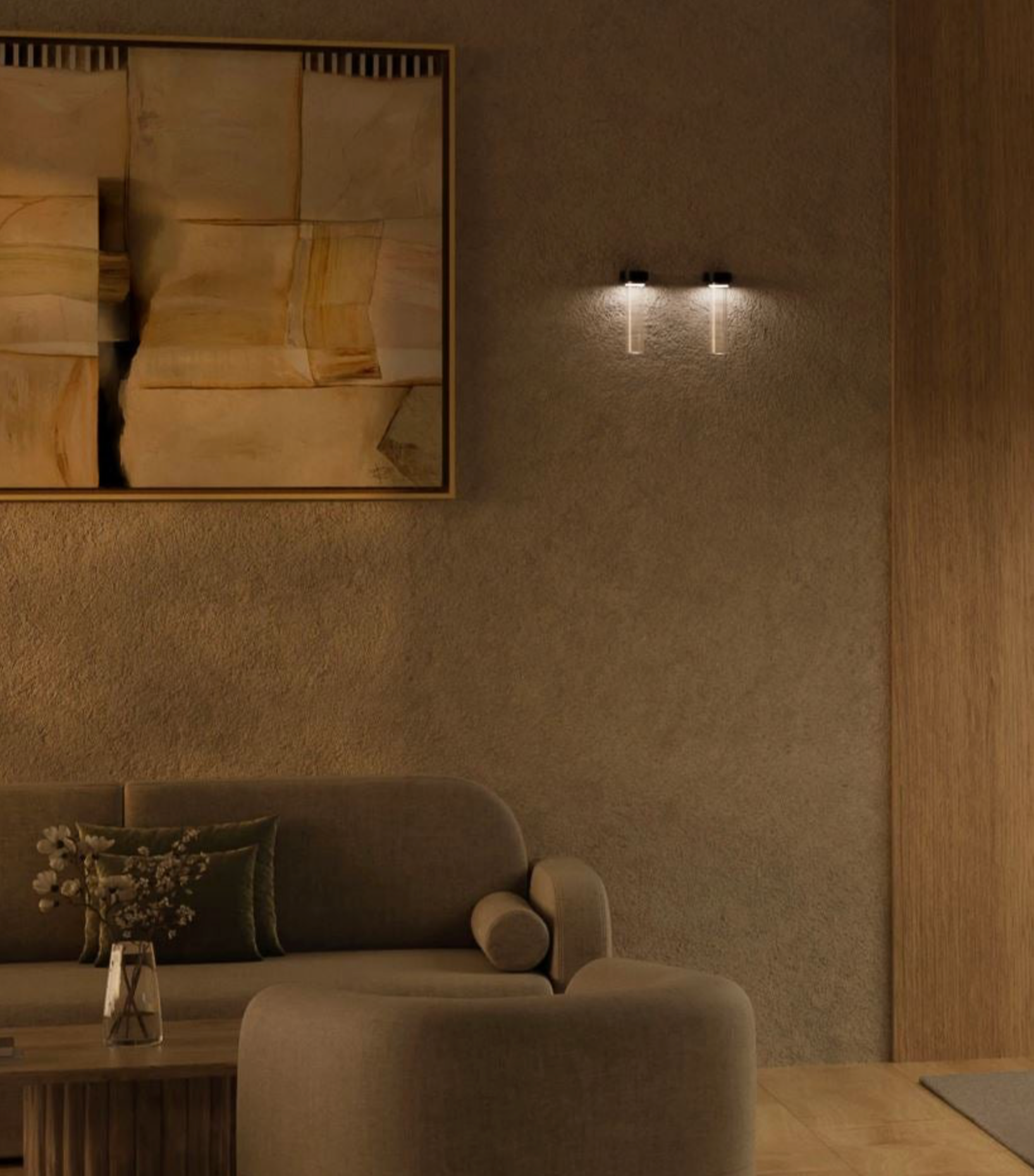 Modern interior with a textured wall, double wall lights framed abstract art, and a sofa.
