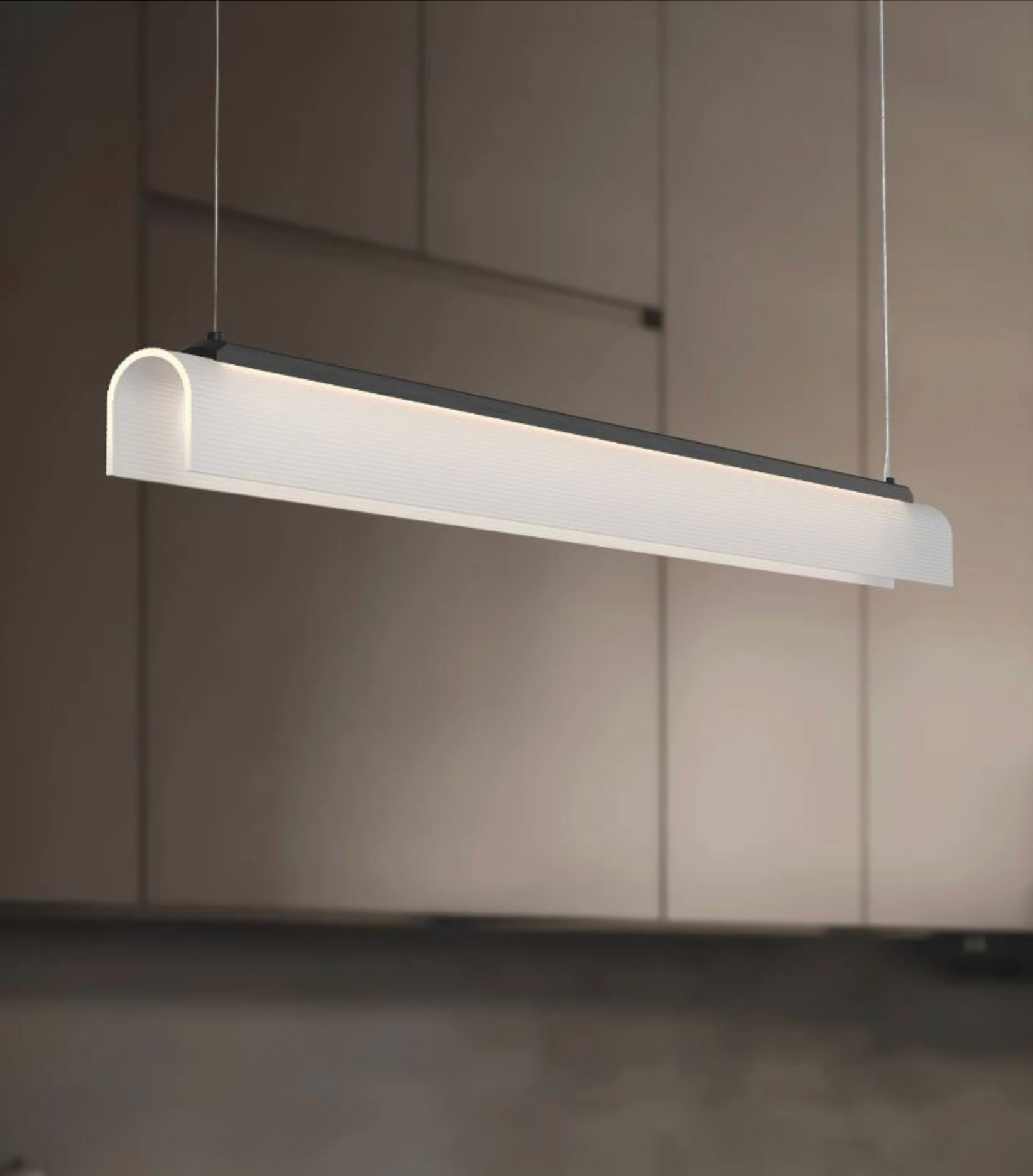 Modern linear pendant light fixture hanging against a neutral kitchen background
