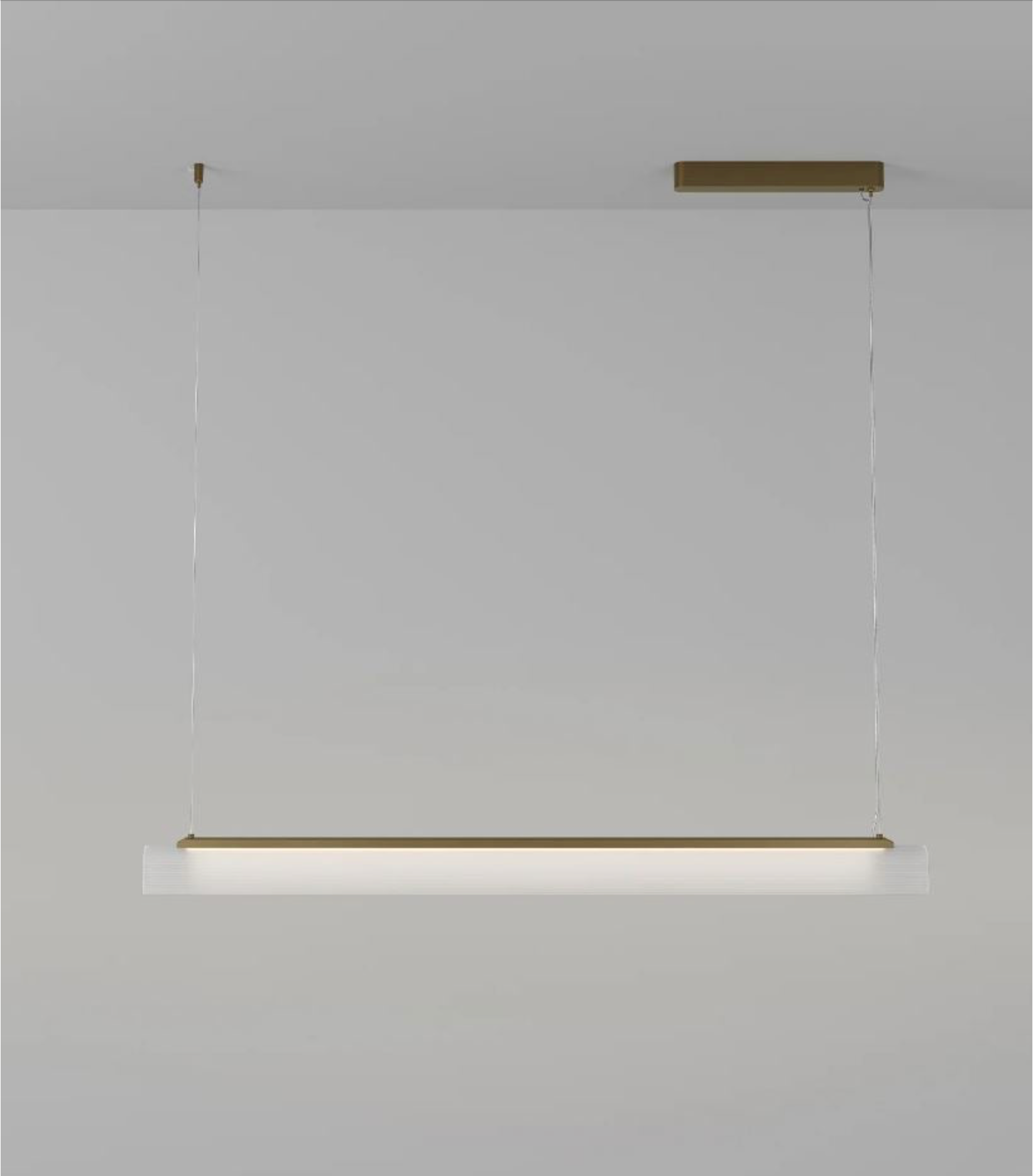 Modern brass and glass linear pendant light fixture on a plain background