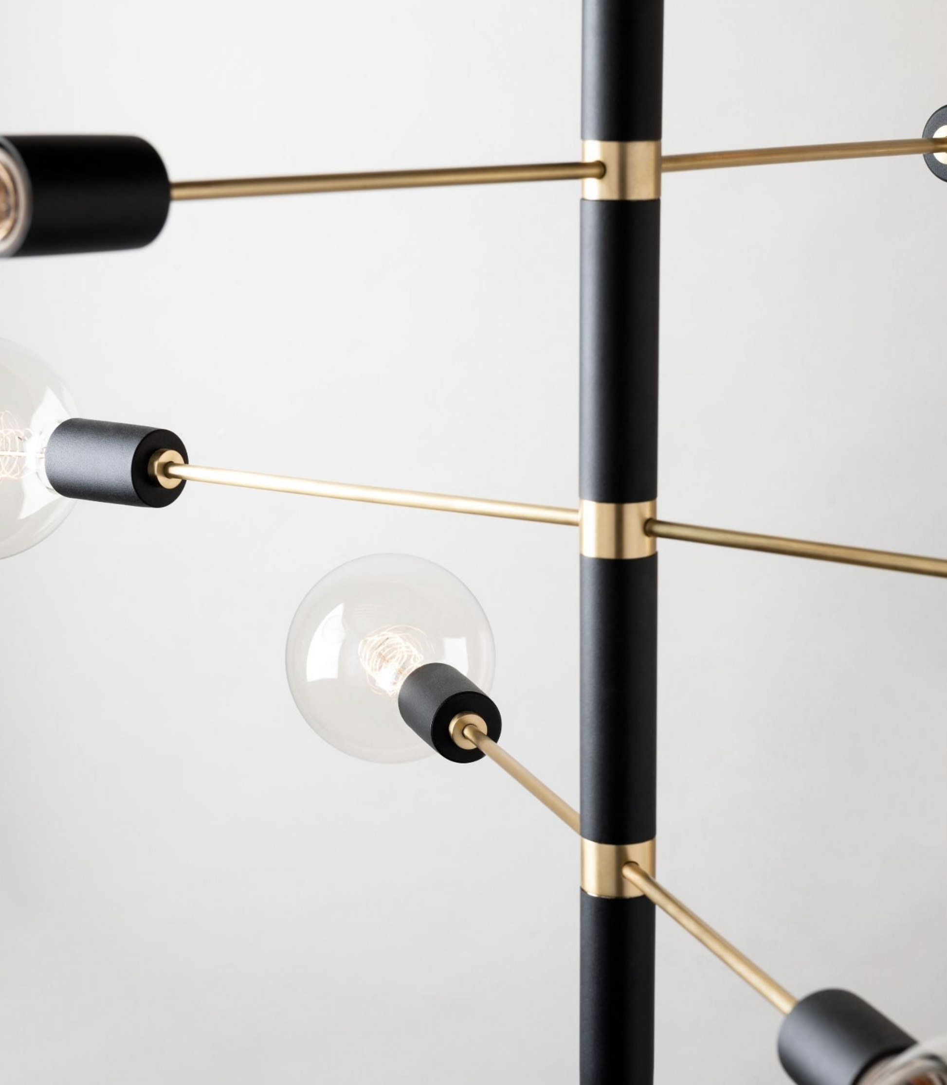 Modern pendant light fixture with black and gold design on a white background