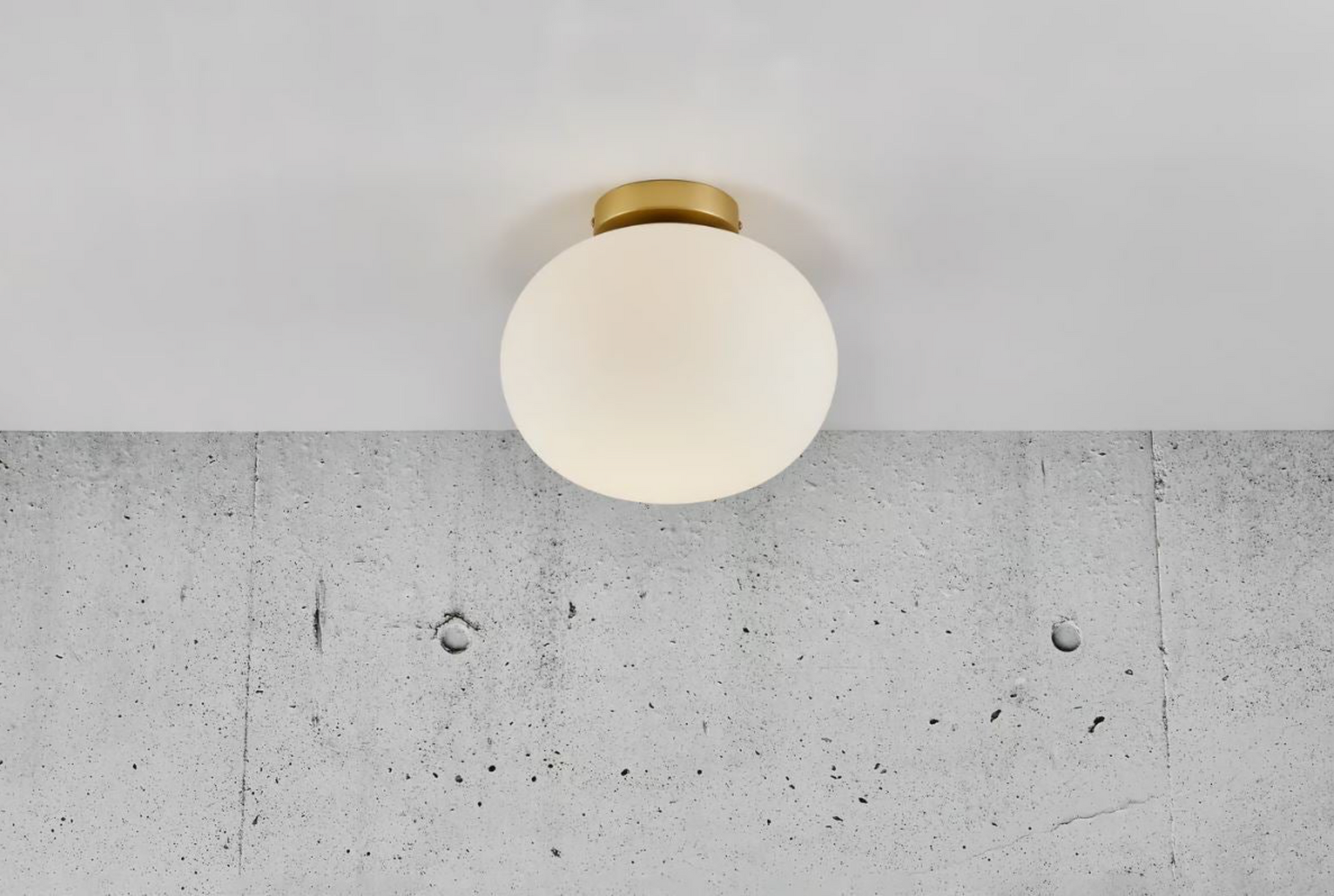 Ceiling light fixture on a concrete wall with a white ceiling