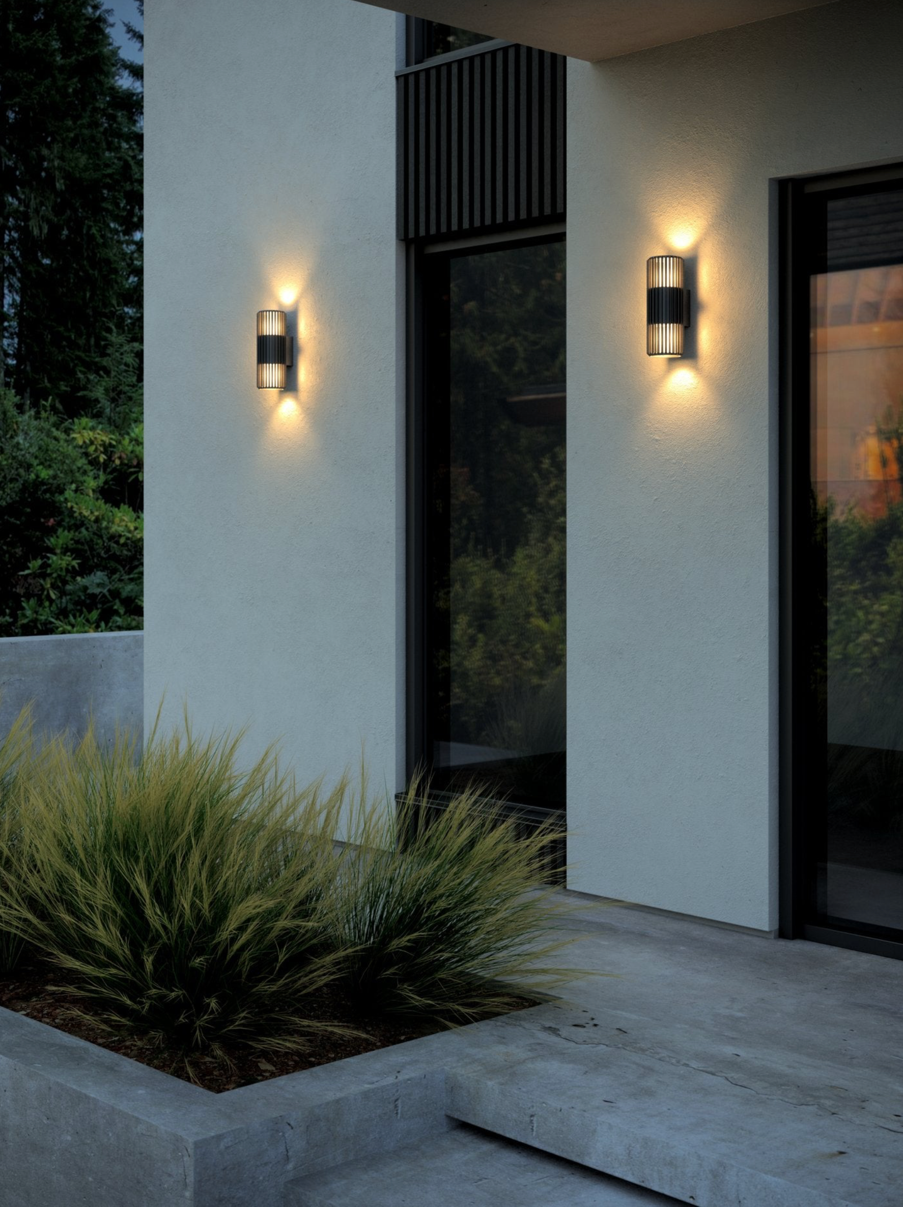 Modern outdoor wall lights on a building exterior with plants and steps.