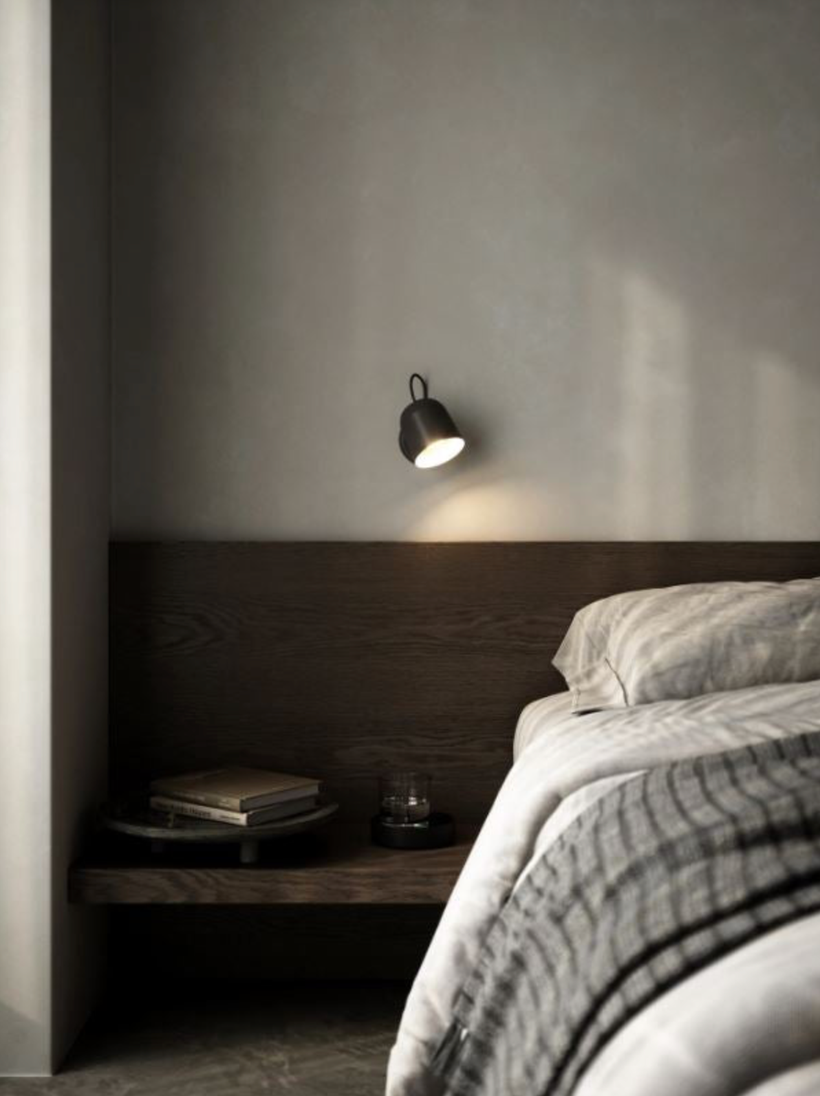 Modern bedroom with a bed, nightstand, and wall-mounted light fixture.