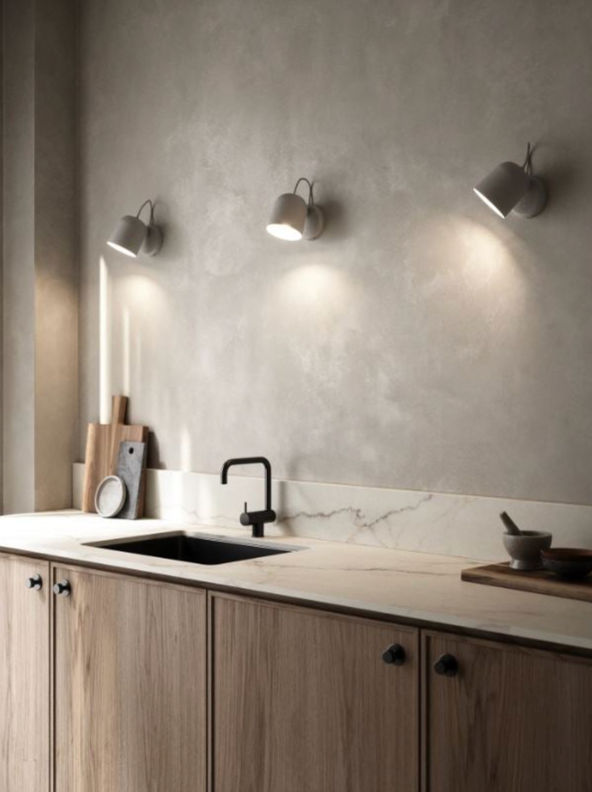 Modern kitchen with wooden cabinets, marble countertop, and 3 wall lights.