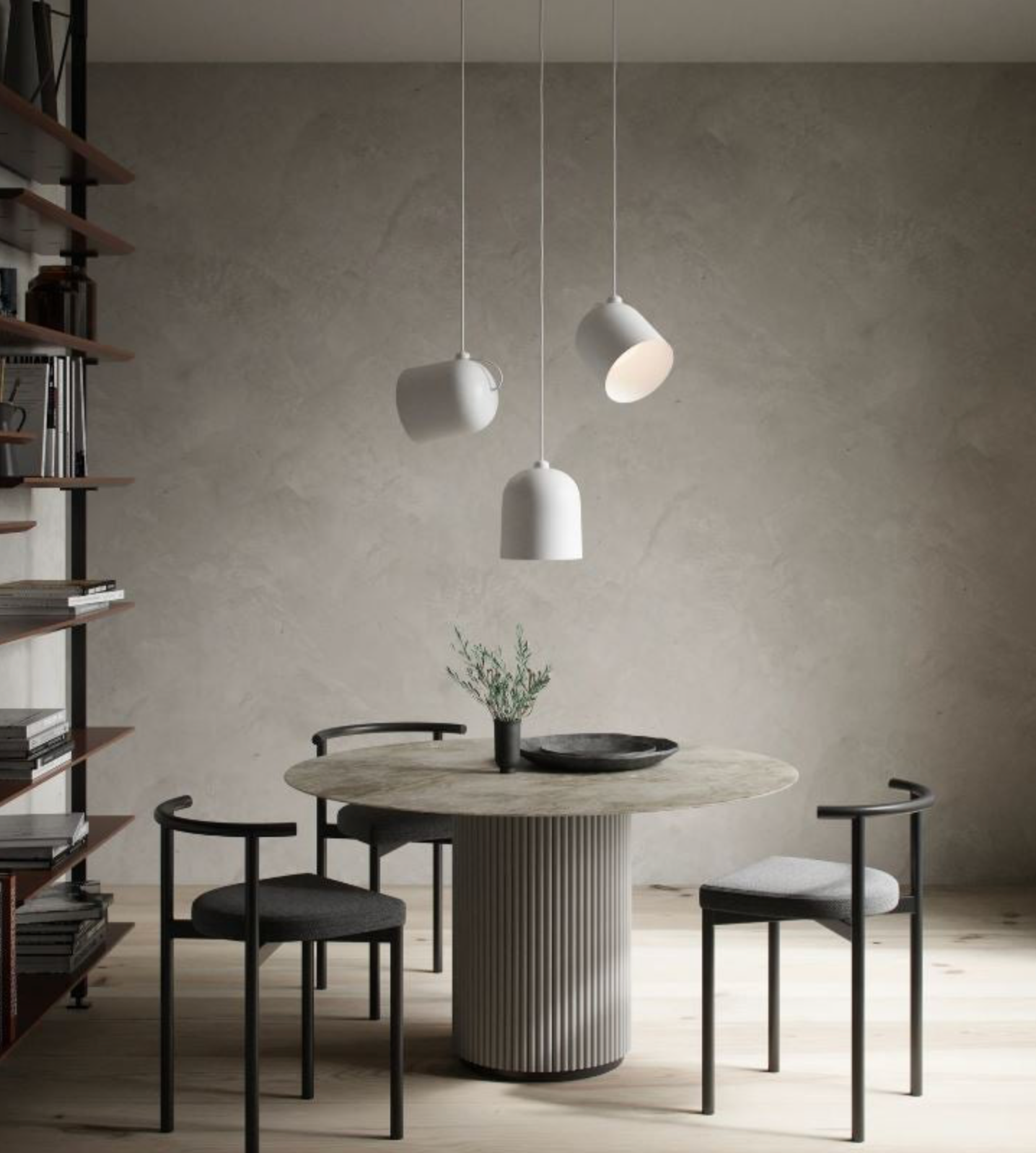 Modern dining area with a round marble table and pendant lights in a minimalistic setting.