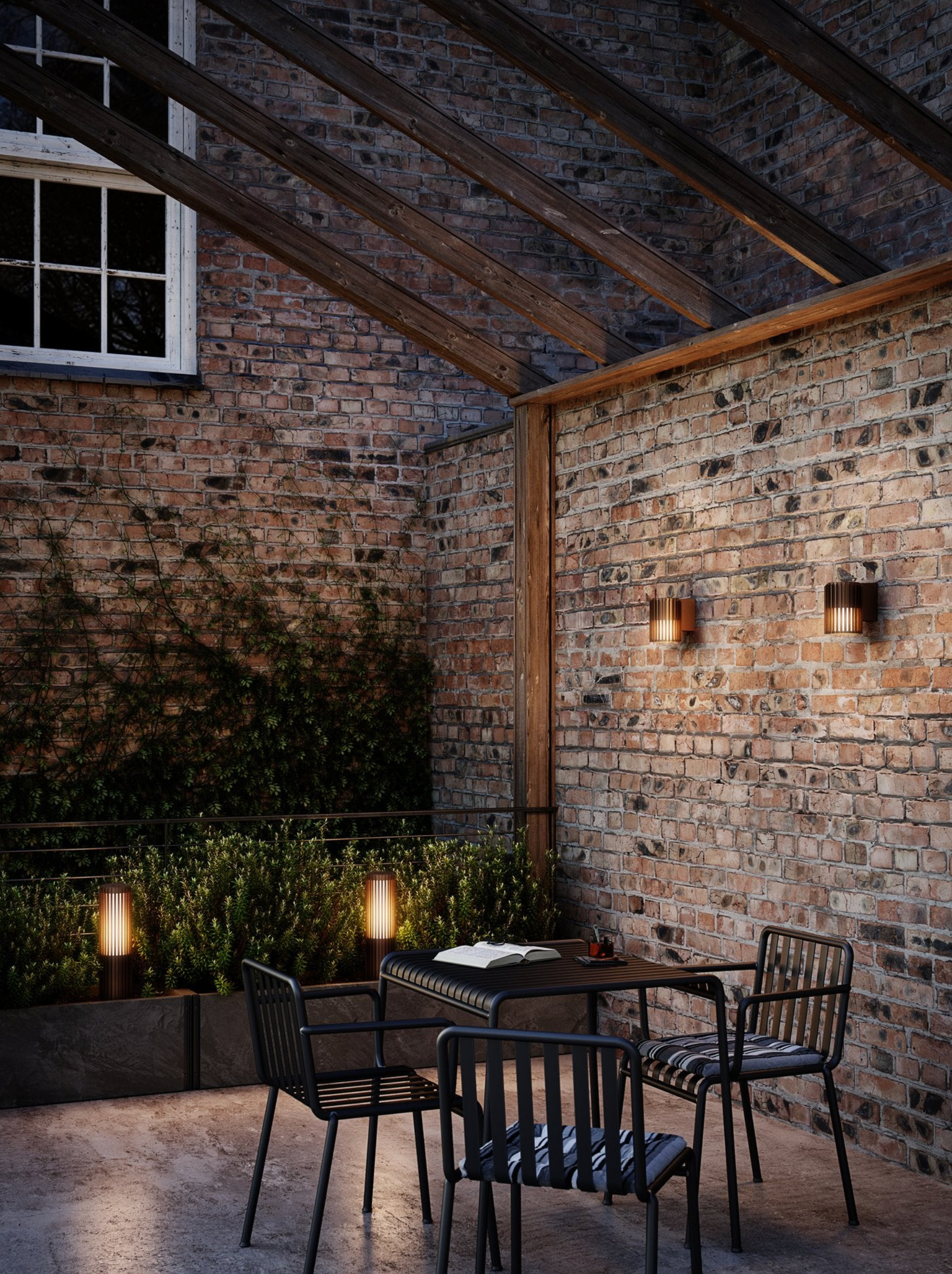 Dining area with brick walls, wooden beams, and outdoor lighting.
