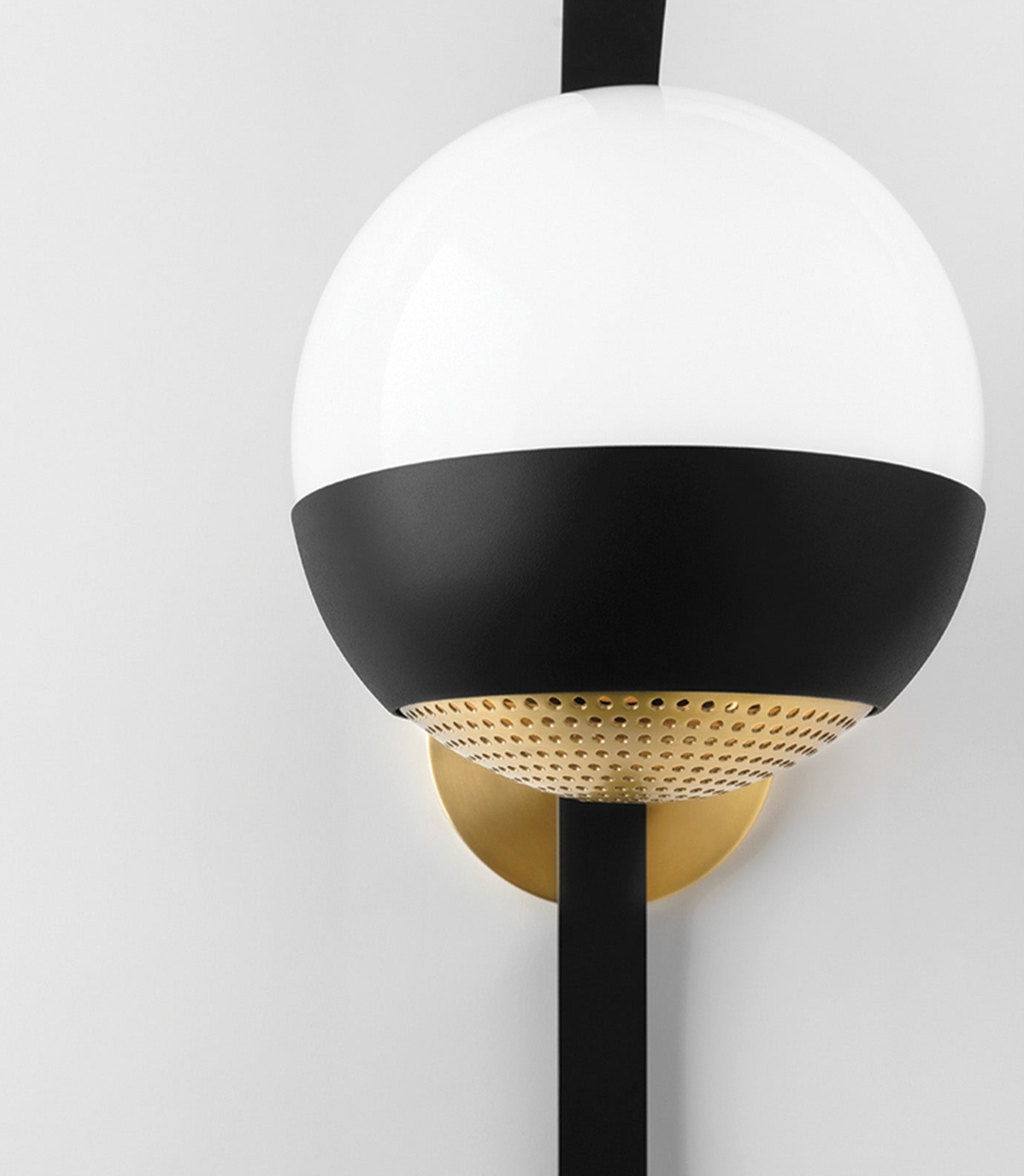 Modern wall sconce with black and white design on a light gray background