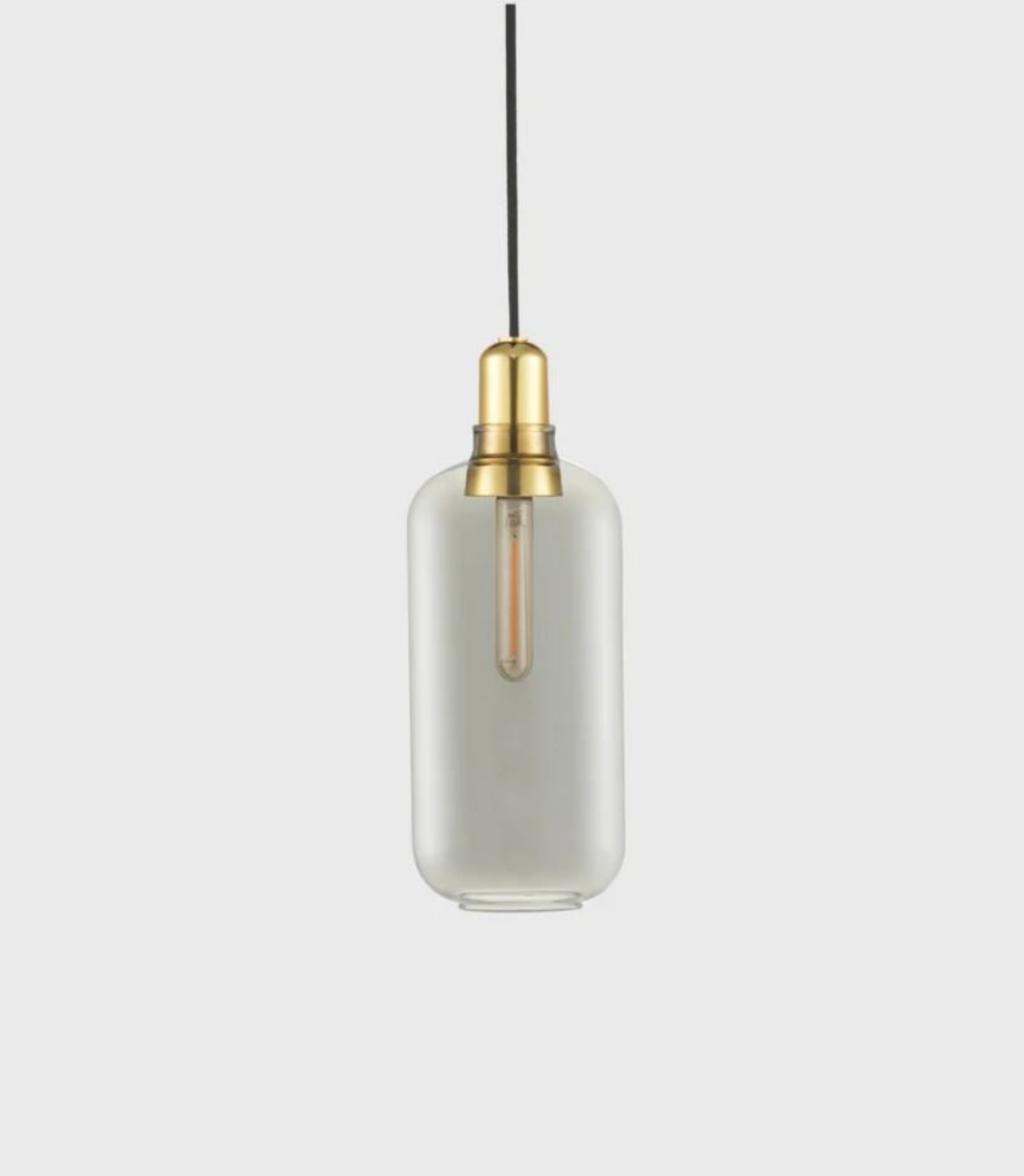 Pendant light with clear glass shade and brass fitting on a white background