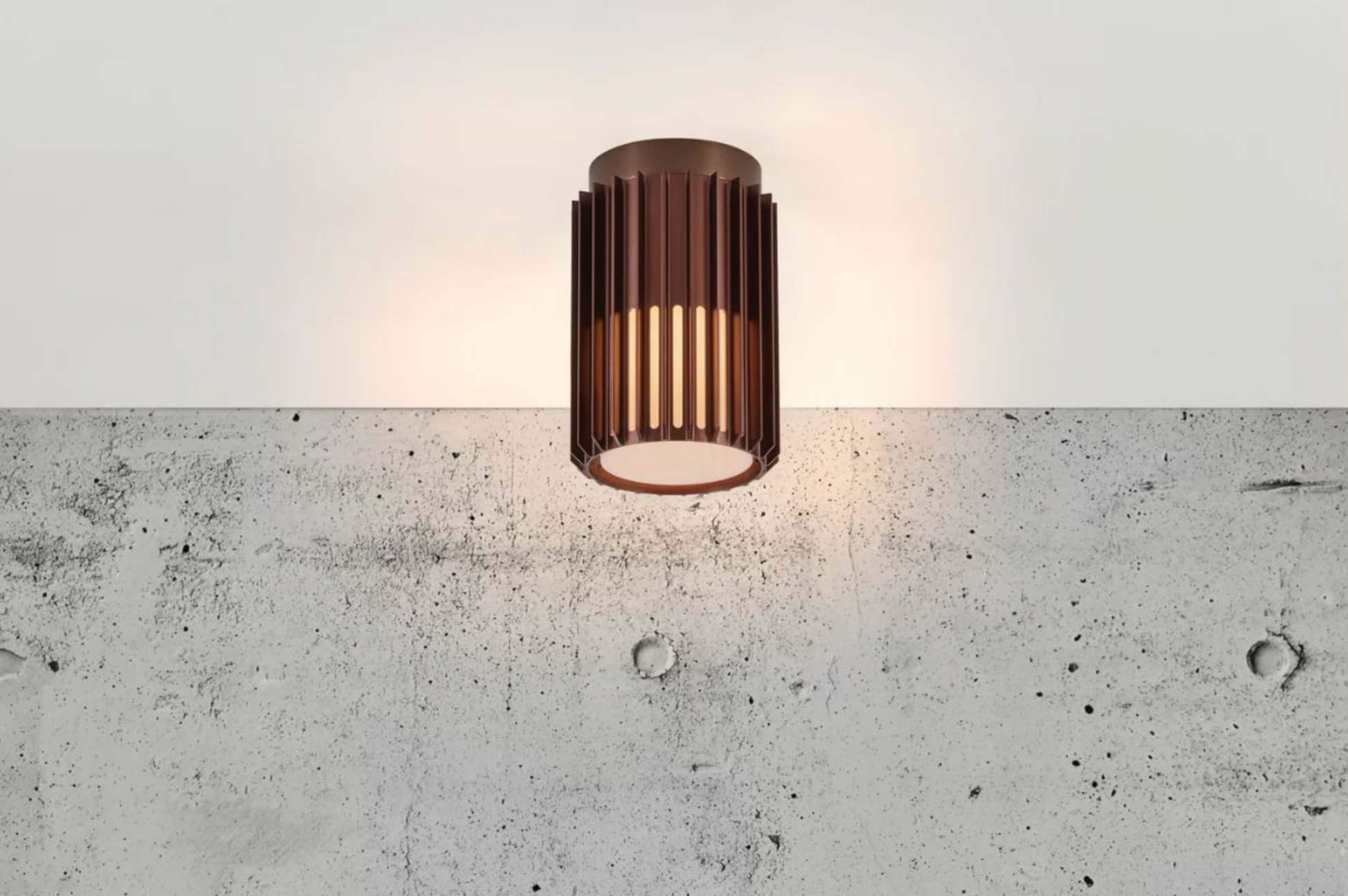 Modern outdoor ceiling light fixture on a concrete wall
