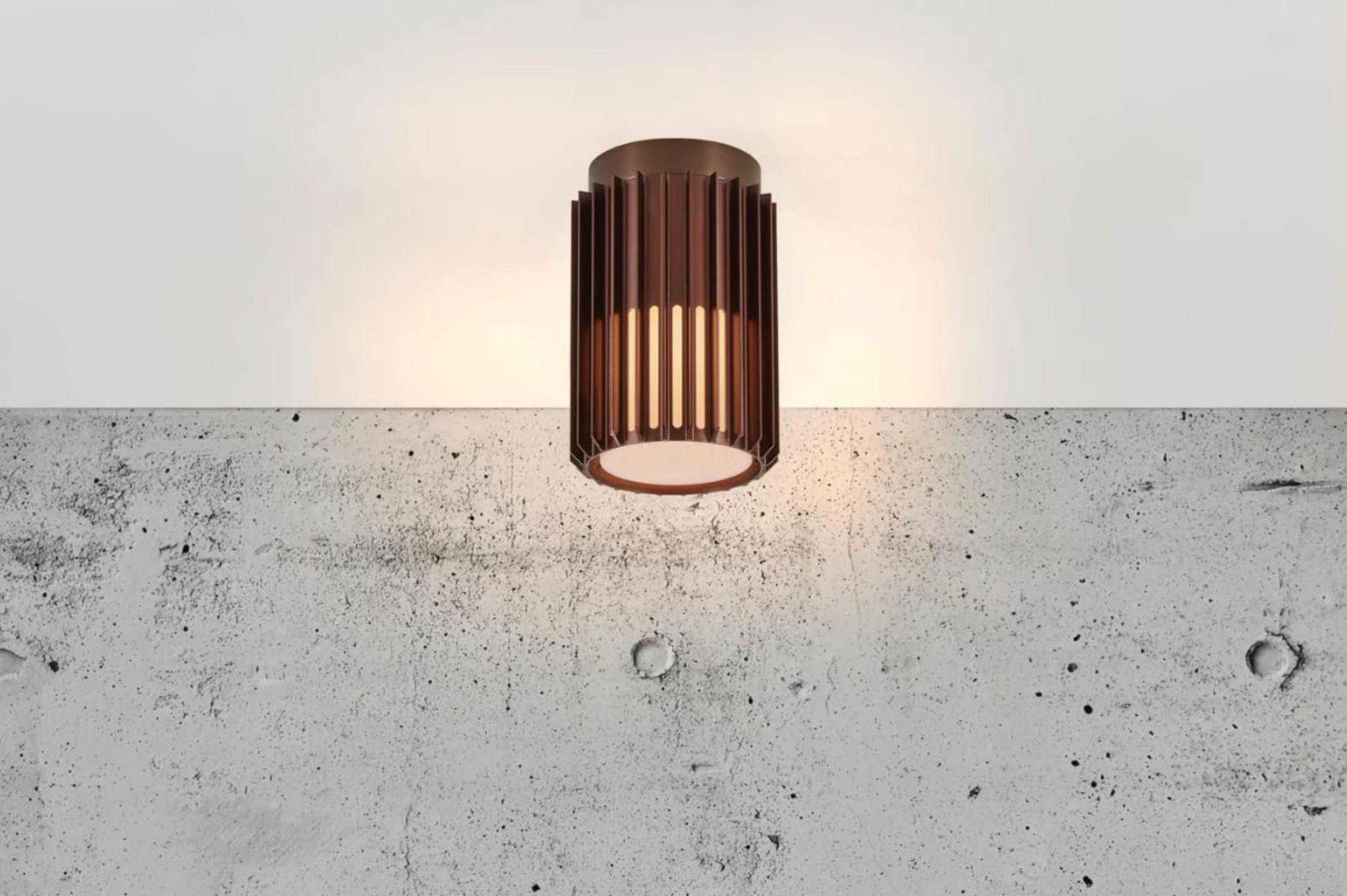 Modern outdoor ceiling light fixture on a concrete wall