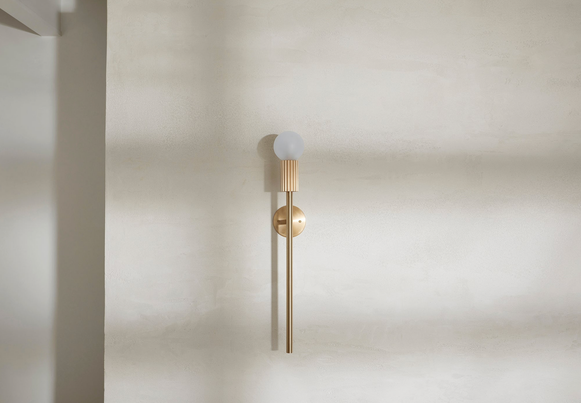 Modern wall-mounted light fixture on a plain wall