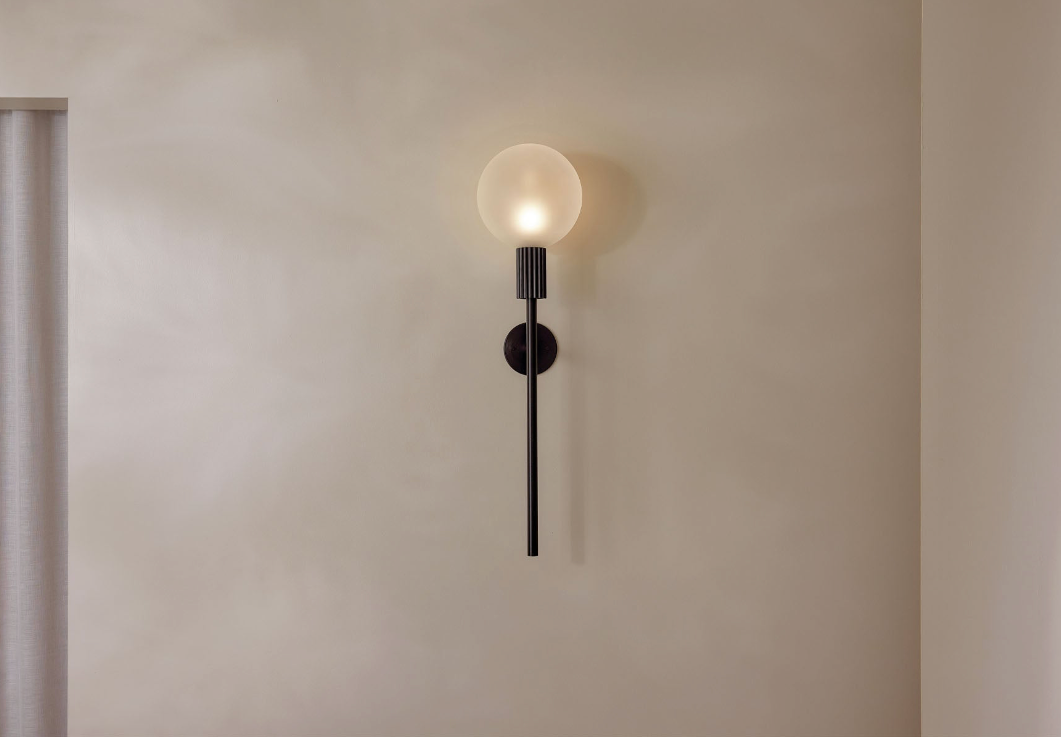 Modern wall-mounted light fixture on a plain wall