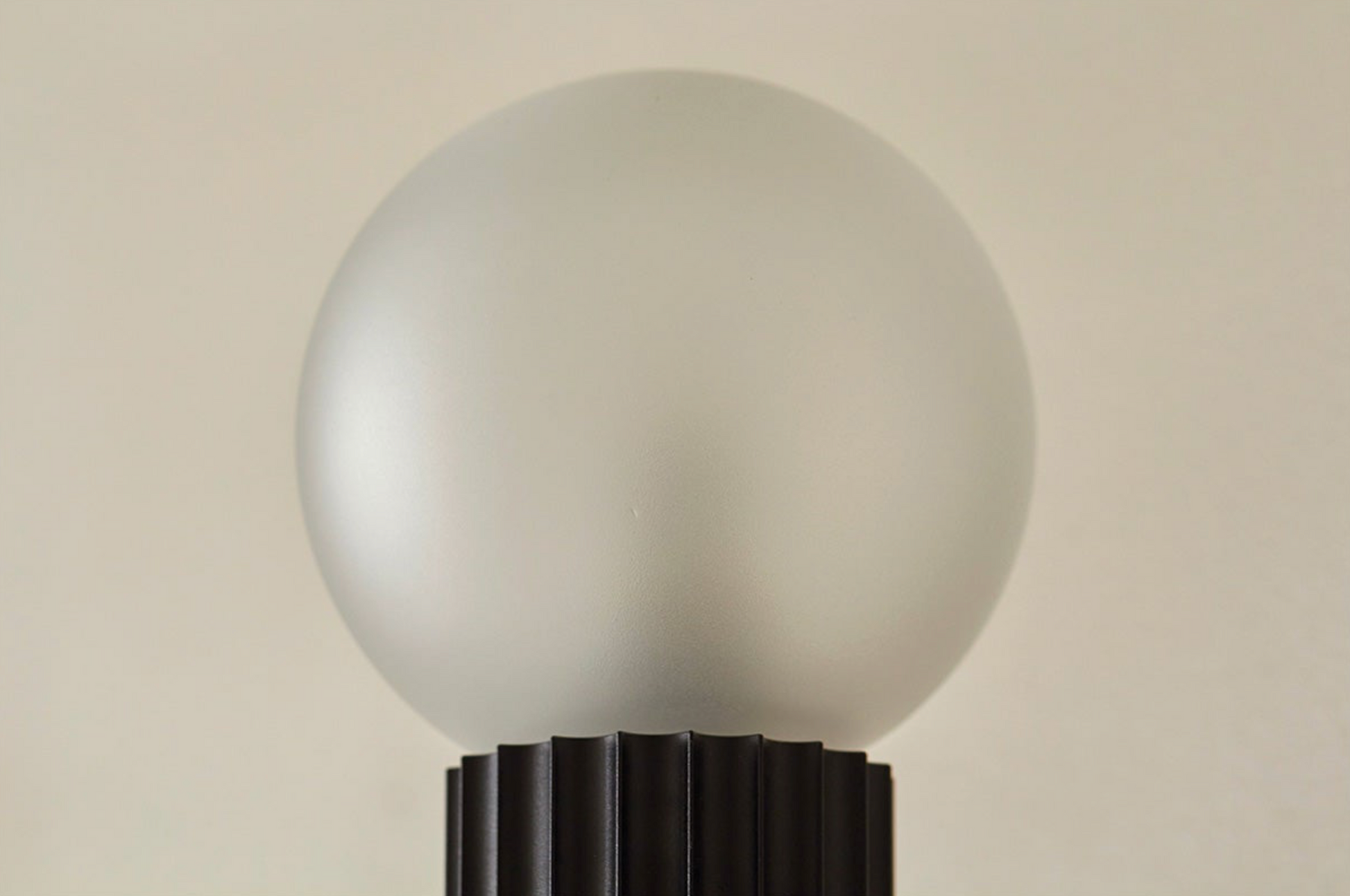 Frosted light bulb on a beige background