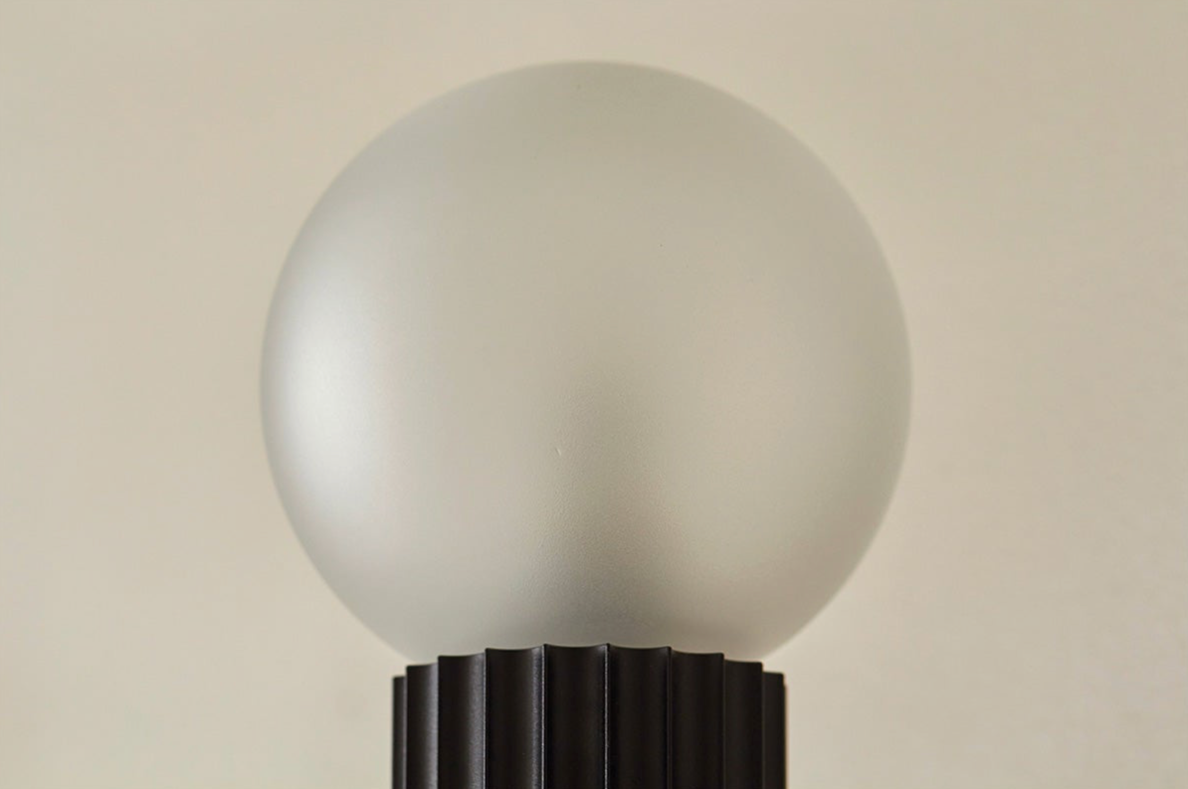 Frosted light bulb on a beige background