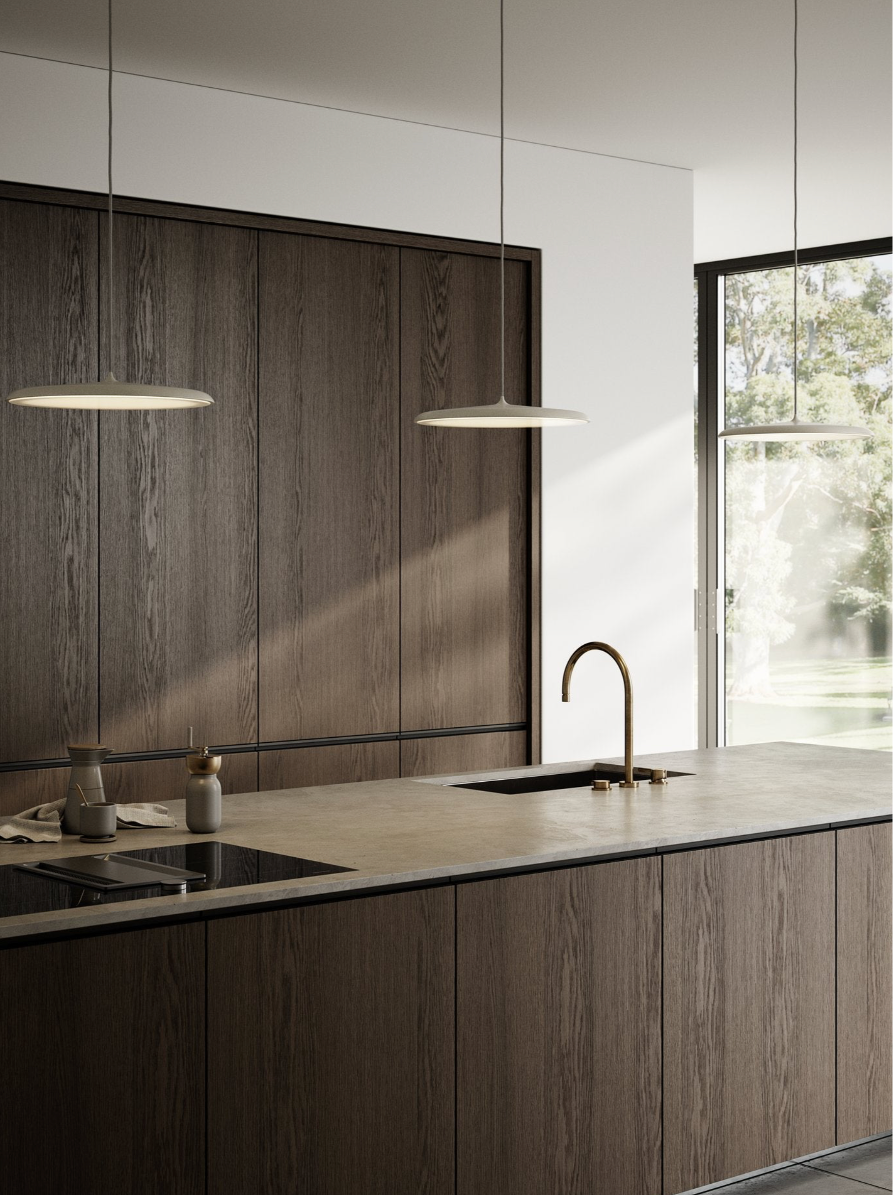Modern kitchen with hanging pendant lights, wooden cabinets, a sink, and a window.