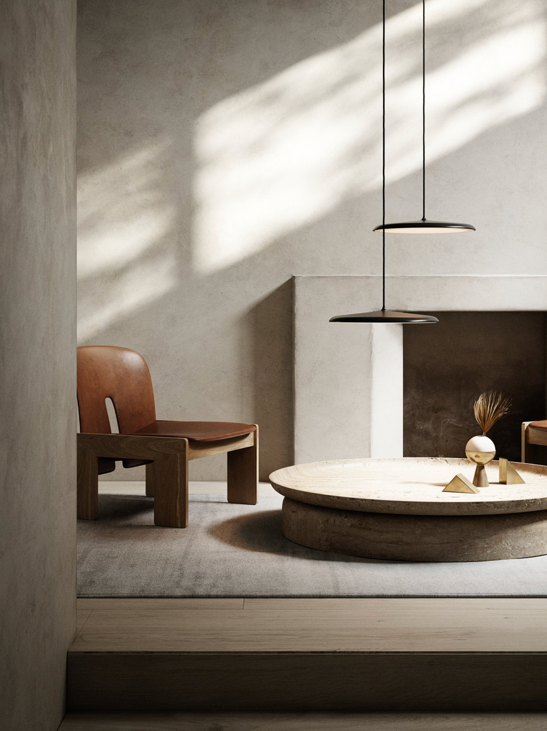 Modern interior with a round table, pendant lights and wooden chair in a softly lit room.