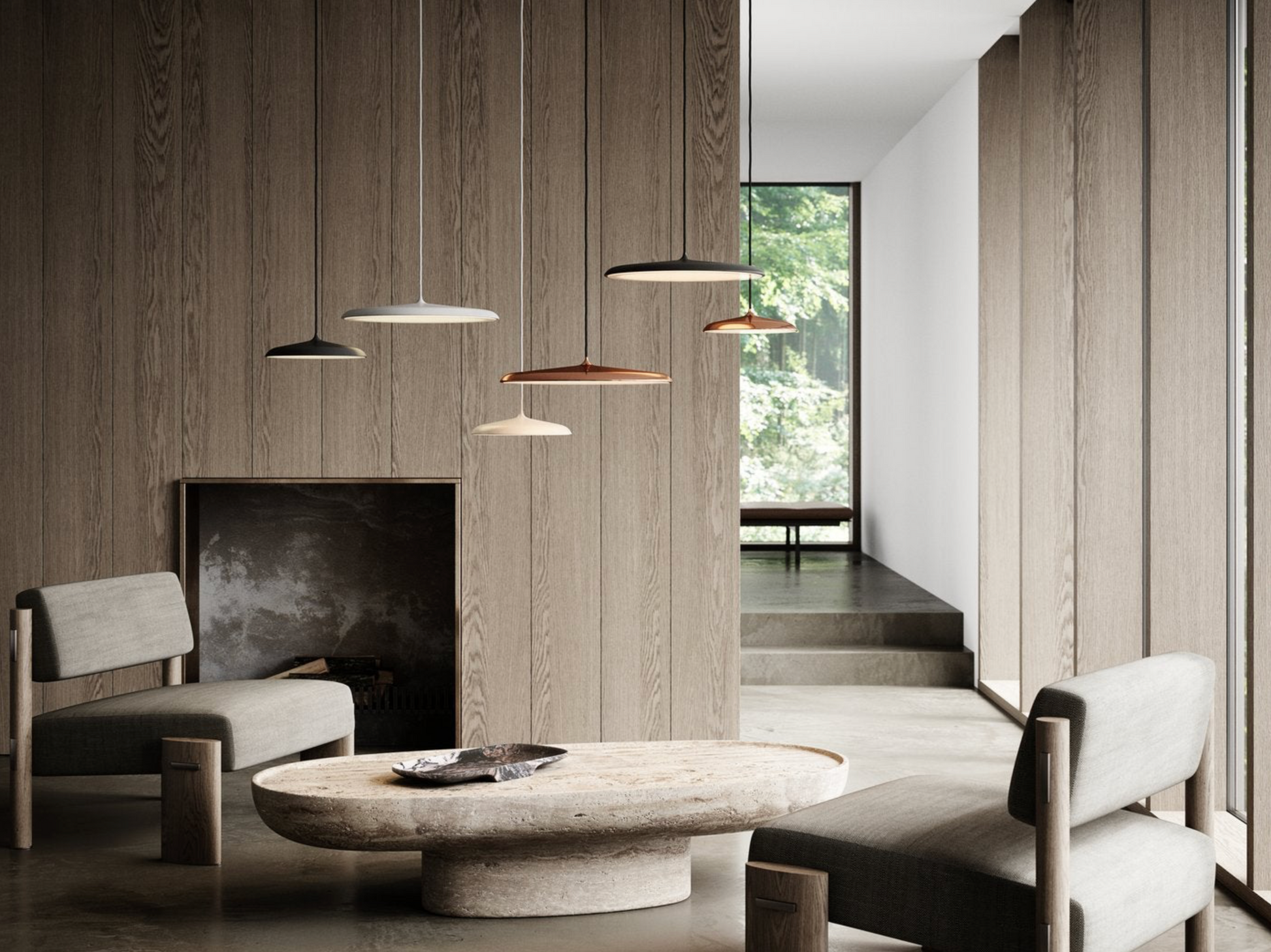 Modern interior with a round stone table, chairs, and pendant lights.