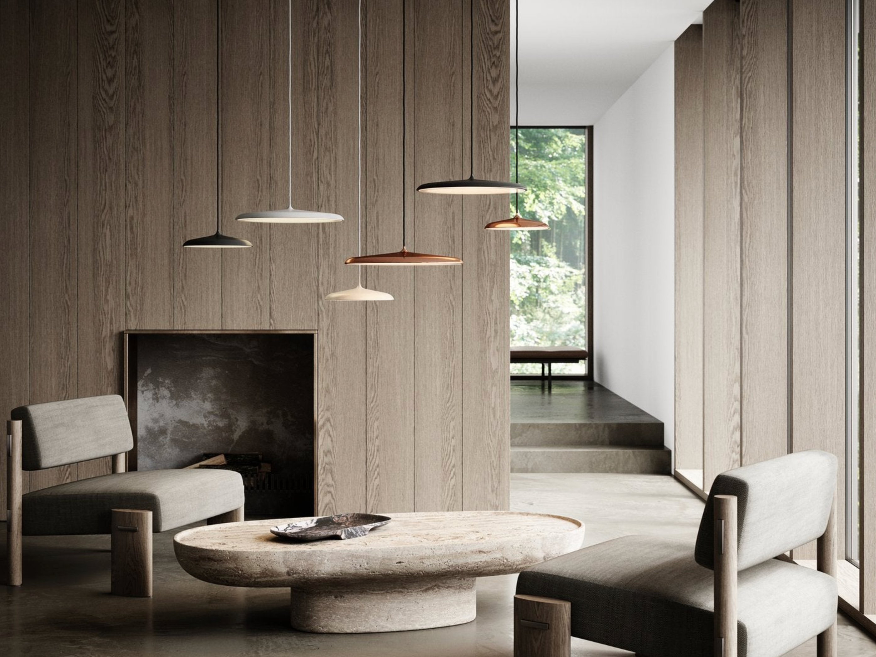 Modern interior with a round stone table, chairs, and pendant lights.