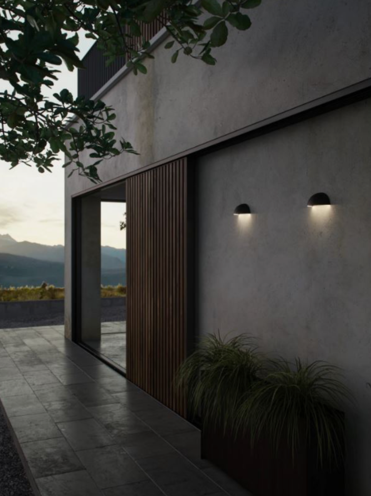 Modern house exterior with sliding glass door and wall lights, mountains in the background