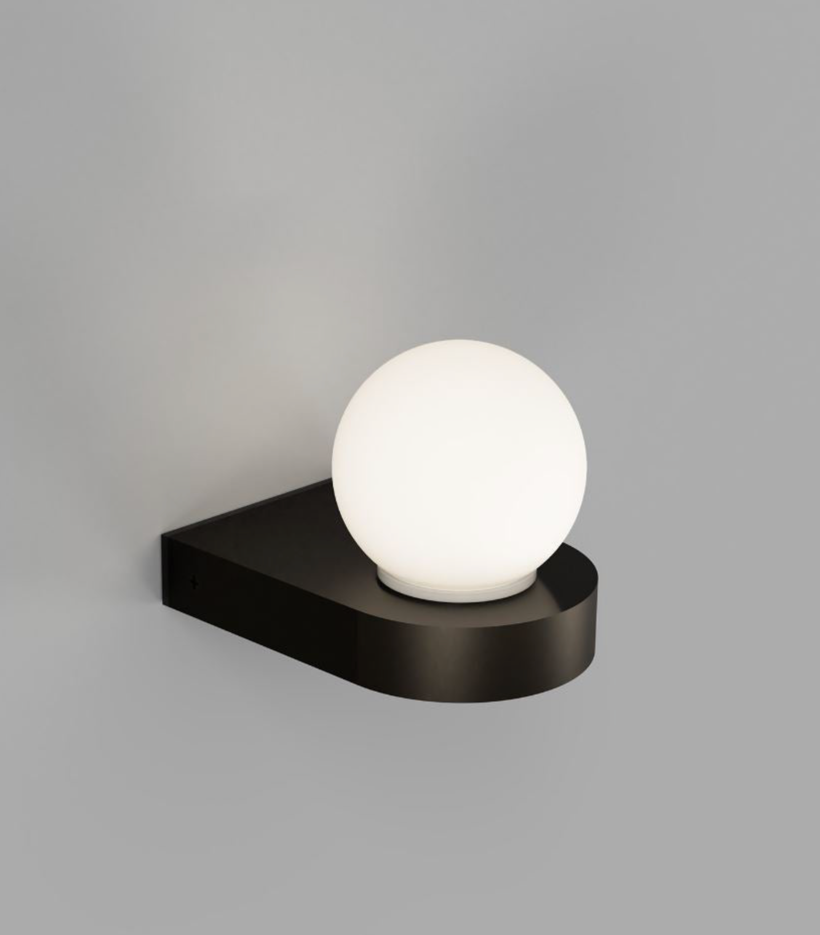 Wall-mounted light fixture with a white globe on a grey background