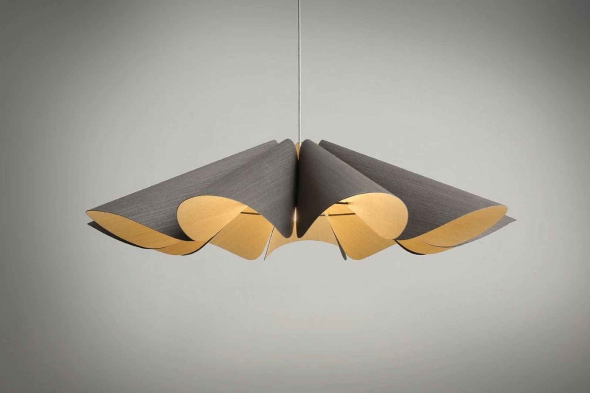 Modern pendant light with grey and gold design on a gray background