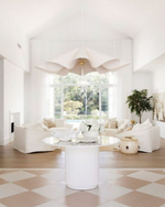 Modern living room with white furniture and large feature pendant light.