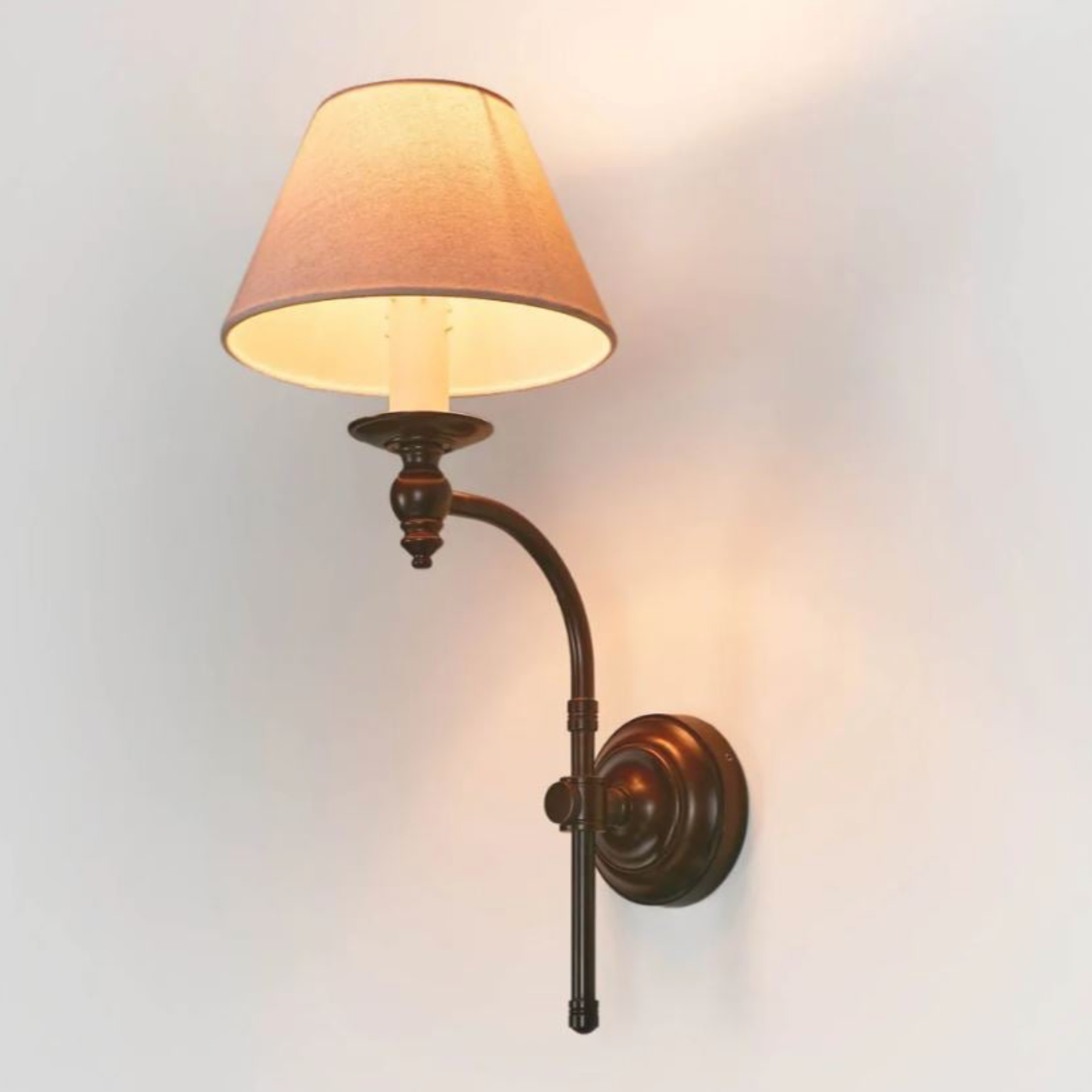 Wall-mounted lamp with a beige shade on a light gray background