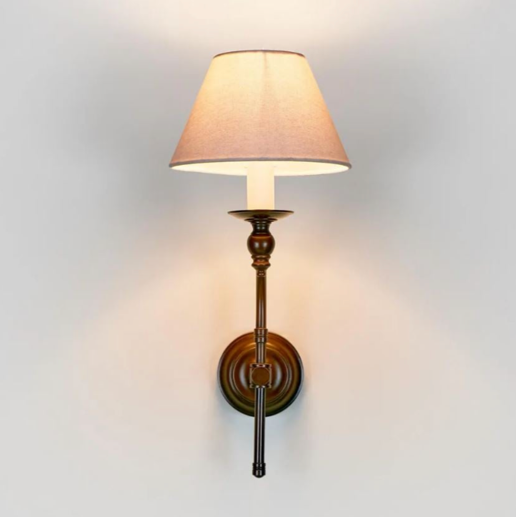 Wall-mounted lamp with a beige shade on a light gray background