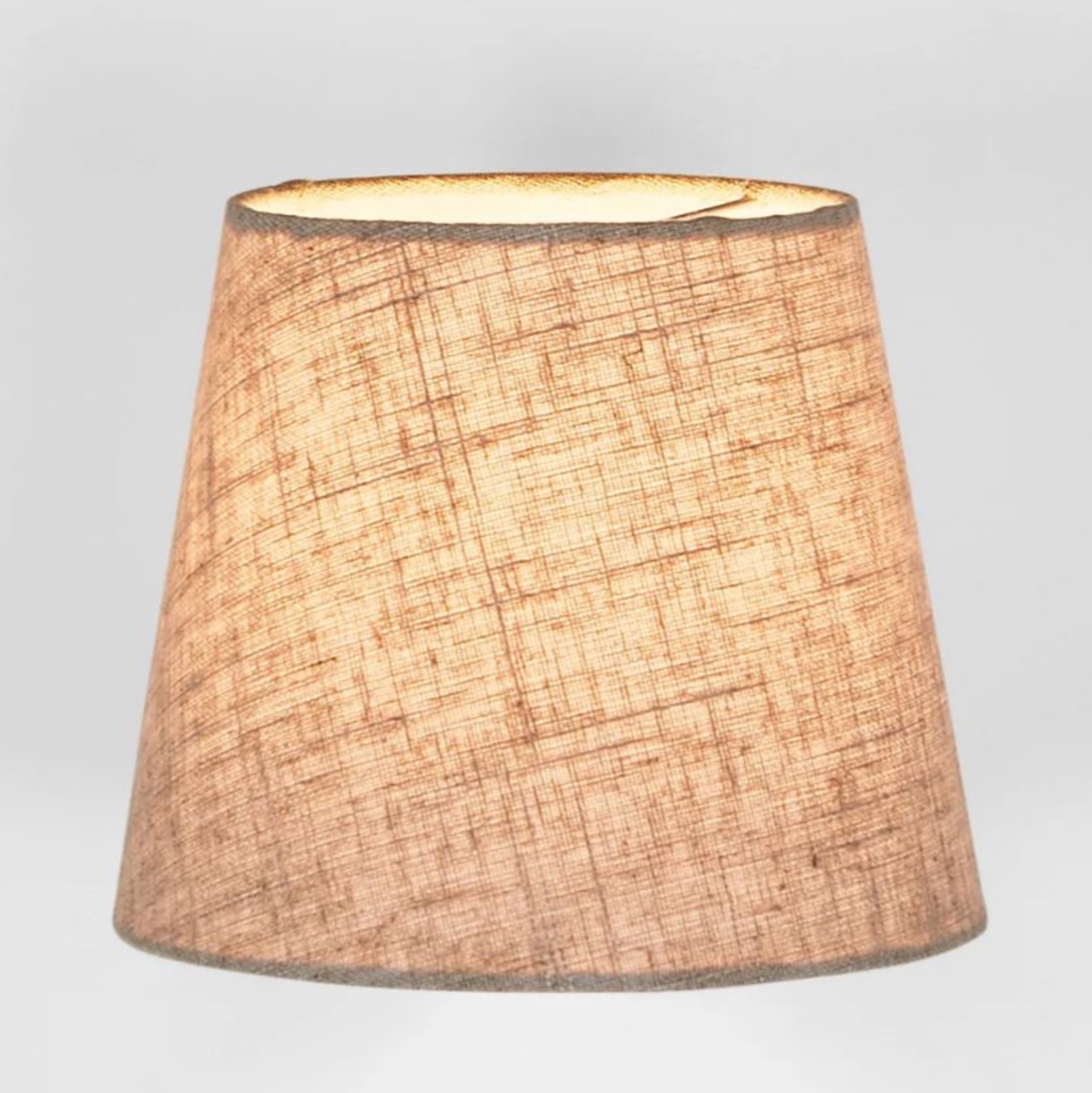 Textured beige lampshade on a light gray background